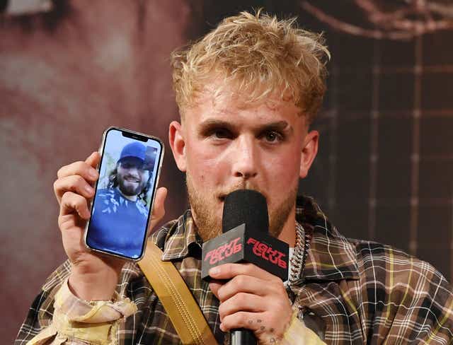 <p>Jake Paul talks to Jorge Masvidal on his phone during a news conference for Triller Fight Club's inaugural boxing event at The Venetian Las Vegas in 2021 </p>