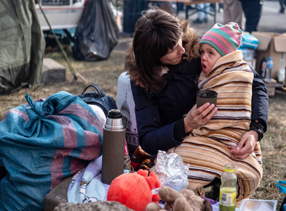 <p>A mother and child near the Polish-Ukrainian border in Hrebenne, Poland</p>