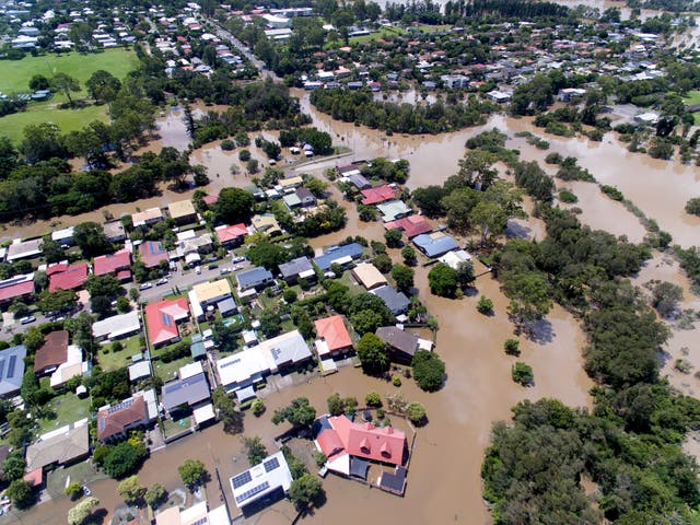 <p>Homes in the suburb of Oxley are seen surrounded by flood waters on 1 March, 2022 in Brisbane, Australia</p>