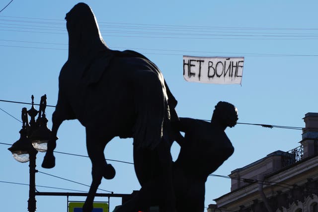 <p>An sign reading “No war” was hung over Nevsky prospect, the central avenue of St Petersburg, Russia, on Tuesday</p>