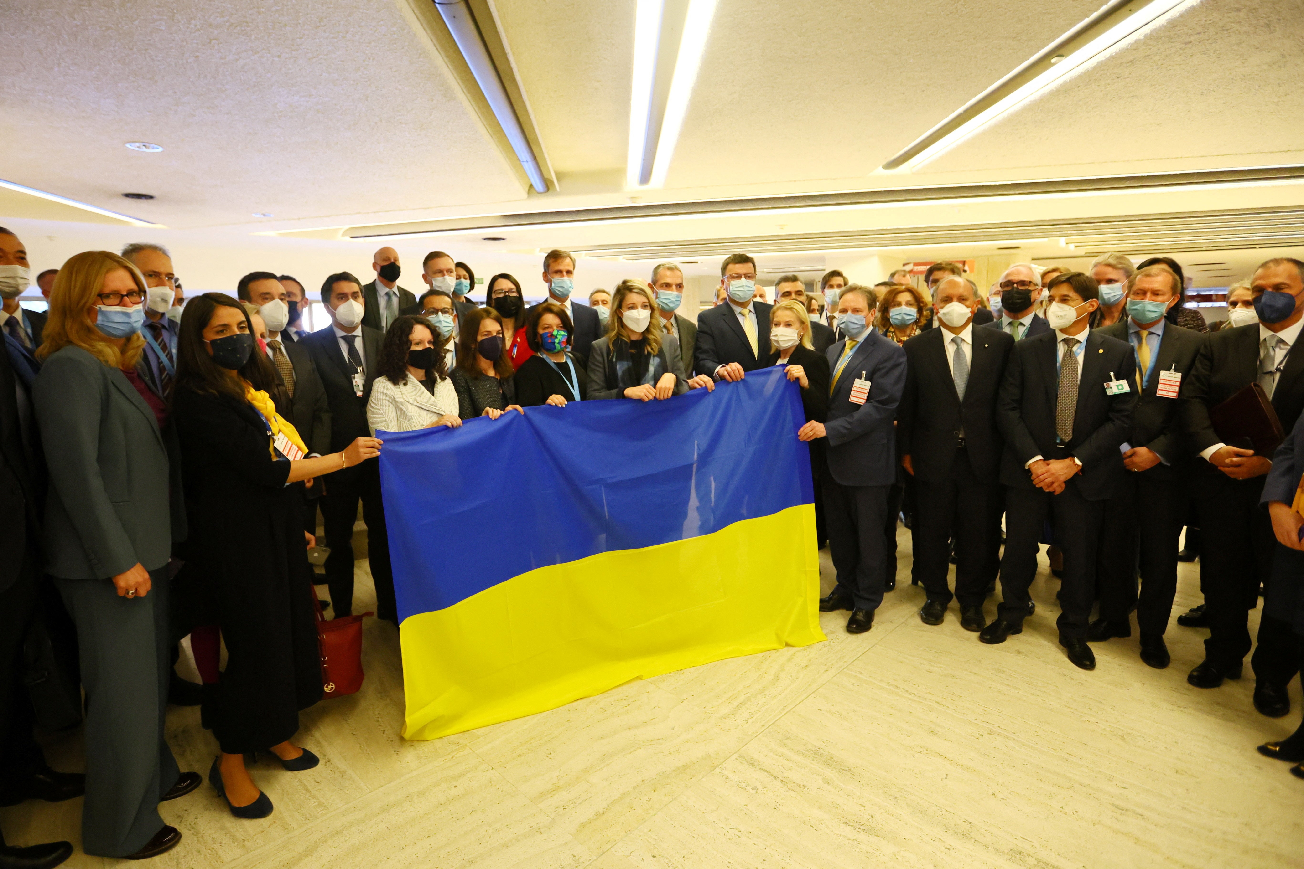 Melanie Joly, Minister of Foreign Affairs of Canada, Ukraine's ambassador Yevheniia Filipenko and other delegates gathered with a Ukrainian flag after walking out of the Human Rights Council meeting.