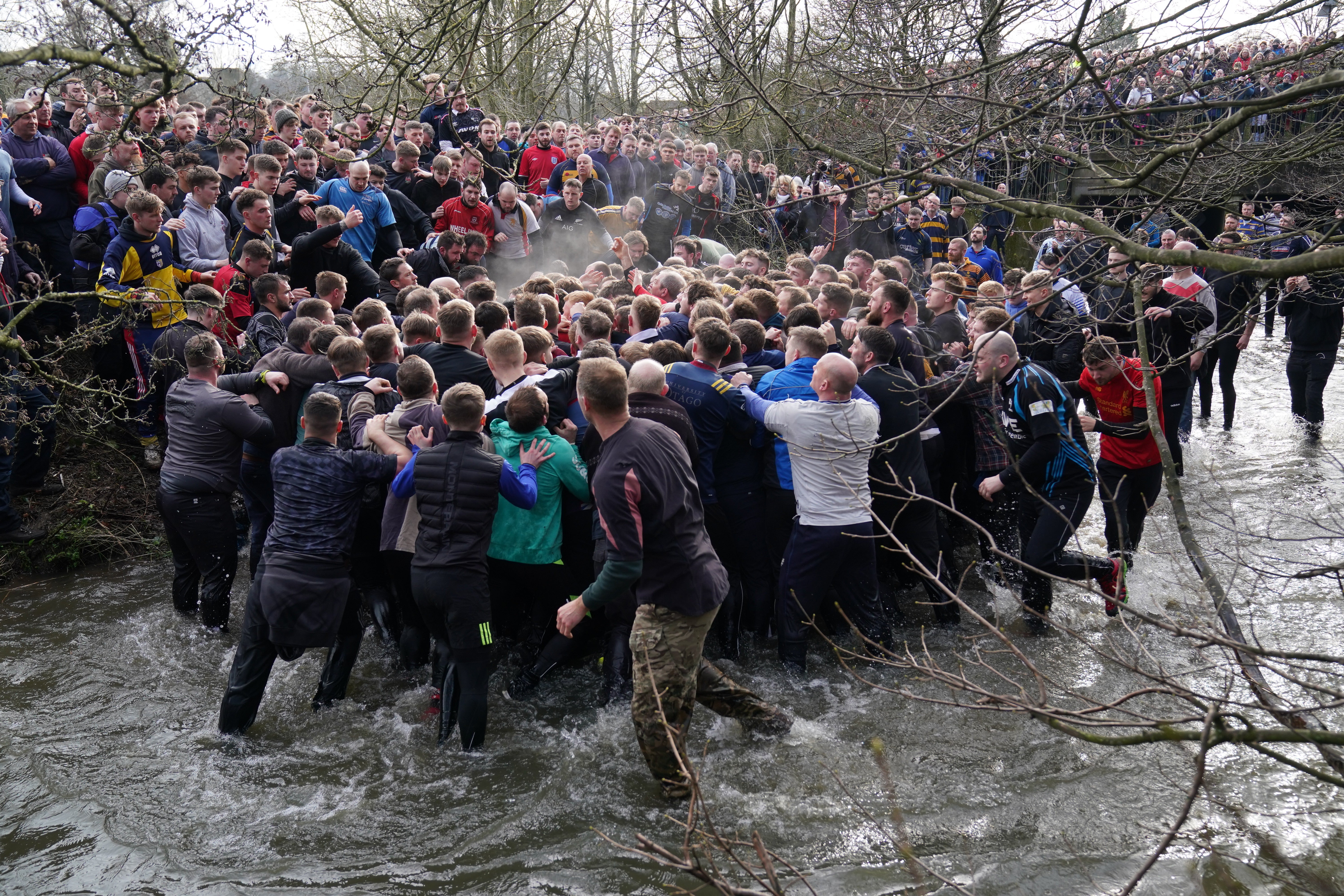 Players take part in the Royal Shrovetide Football Match in Ashbourne (Jacob King/PA)