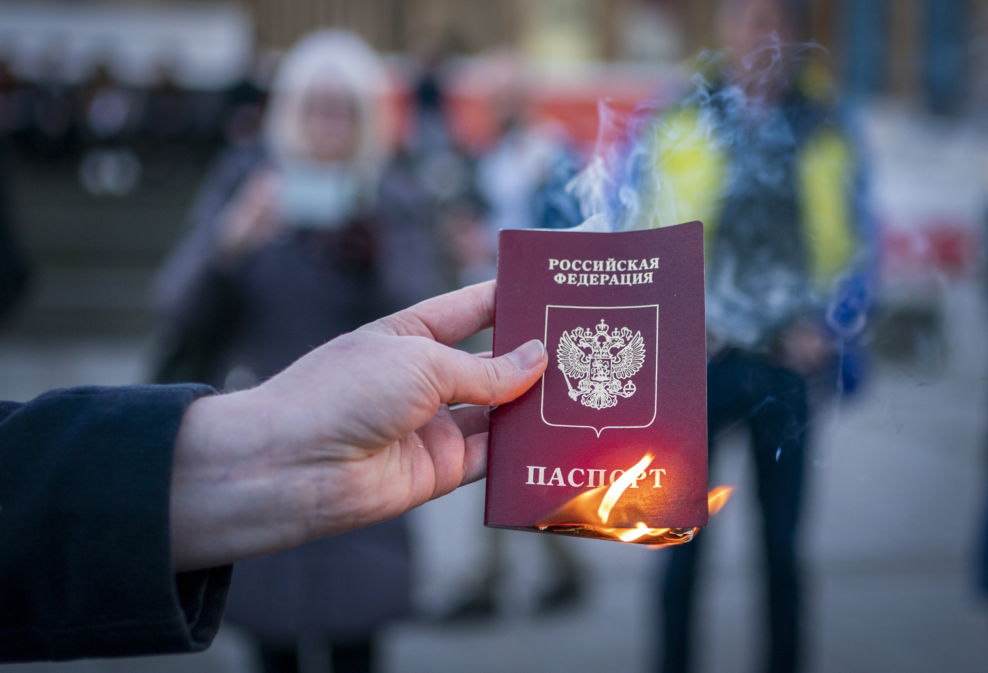 Anna Jakubova sets fire to her Russian passport during the Standing In Solidarity With Ukraine vigil on The Mound, Edinburgh, following the Russian invasion of Ukraine (Jane Barlow/PA)