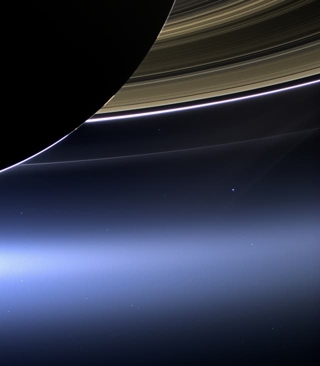 <p>Earth is just a pale blue dot below Saturn’s rings in this image taken by the Cassini probe in 2013</p>