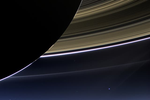 <p>Earth is just a pale blue dot below Saturn’s rings in this image taken by the Cassini probe in 2013</p>