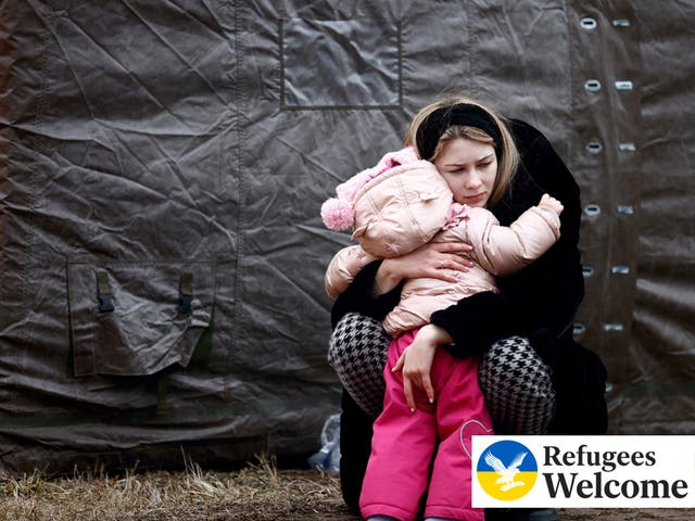 <p>A woman fleeing Russian invasion of Ukraine hugs a child at a temporary camp in Przemysl, Poland, February 28, 2022. </p>