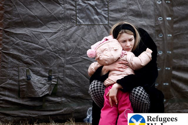 <p>A woman fleeing Russian invasion of Ukraine hugs a child at a temporary camp in Przemysl, Poland, February 28, 2022. </p>