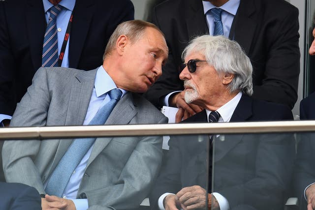 <p>Putin and Ecclestone talk during the Russian Grand Prix in 2018</p>