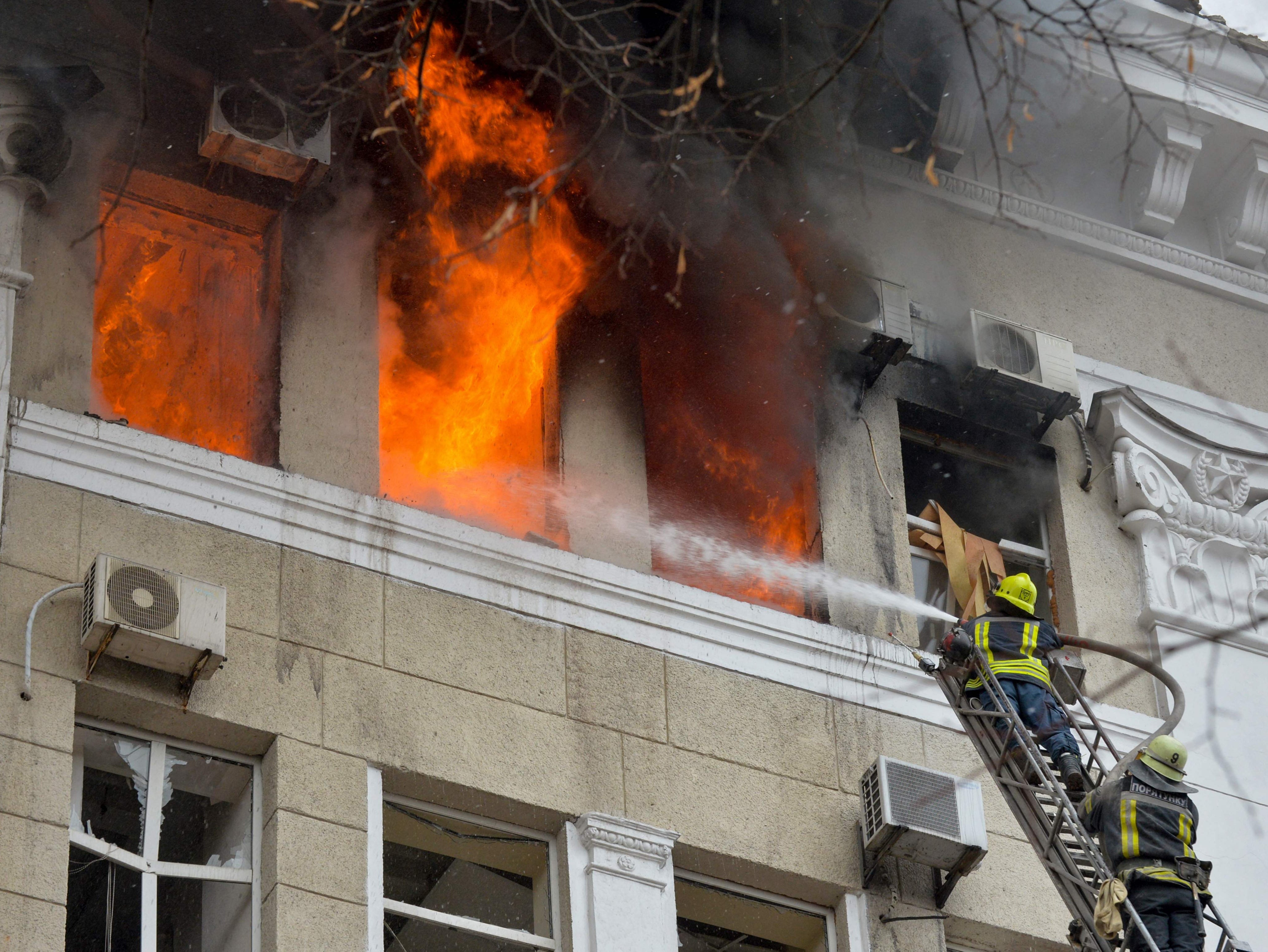 Firefighters battle a fire at the Kharkiv’s regional security service and police