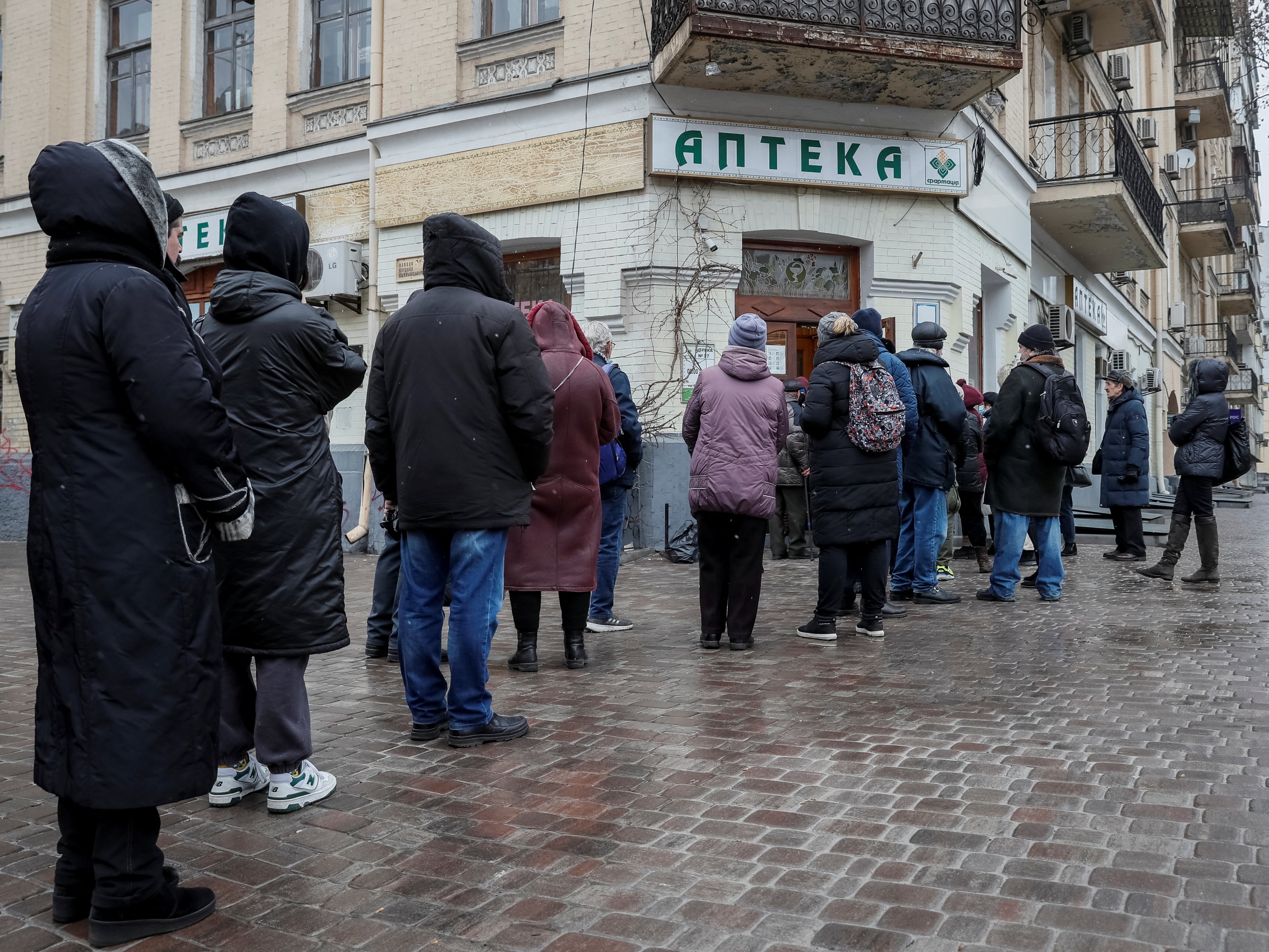 People queue at a Kyiv pharmacy