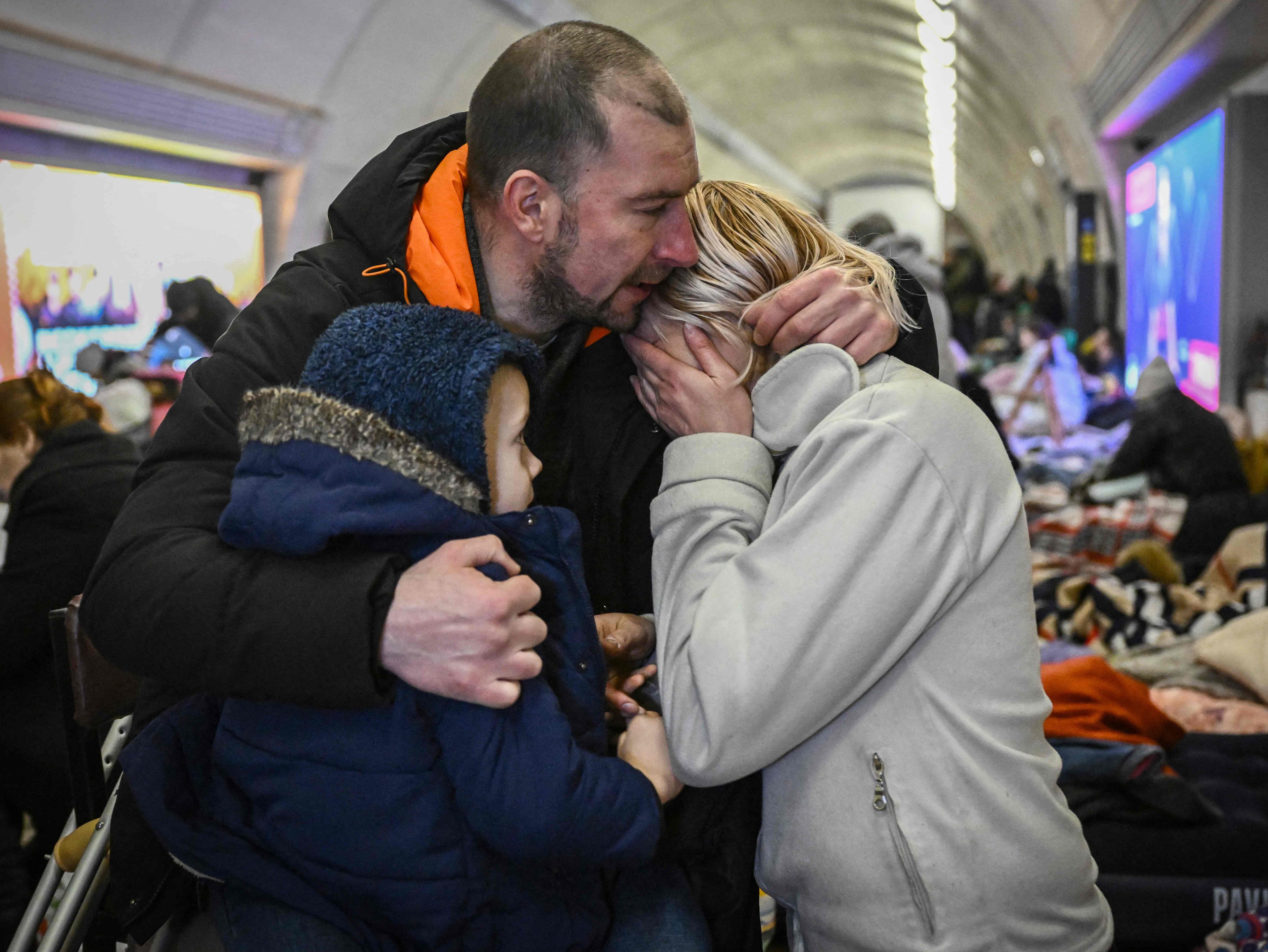Sergyi Badylevych hugs his wife Natalia and son in an underground station in Kyiv
