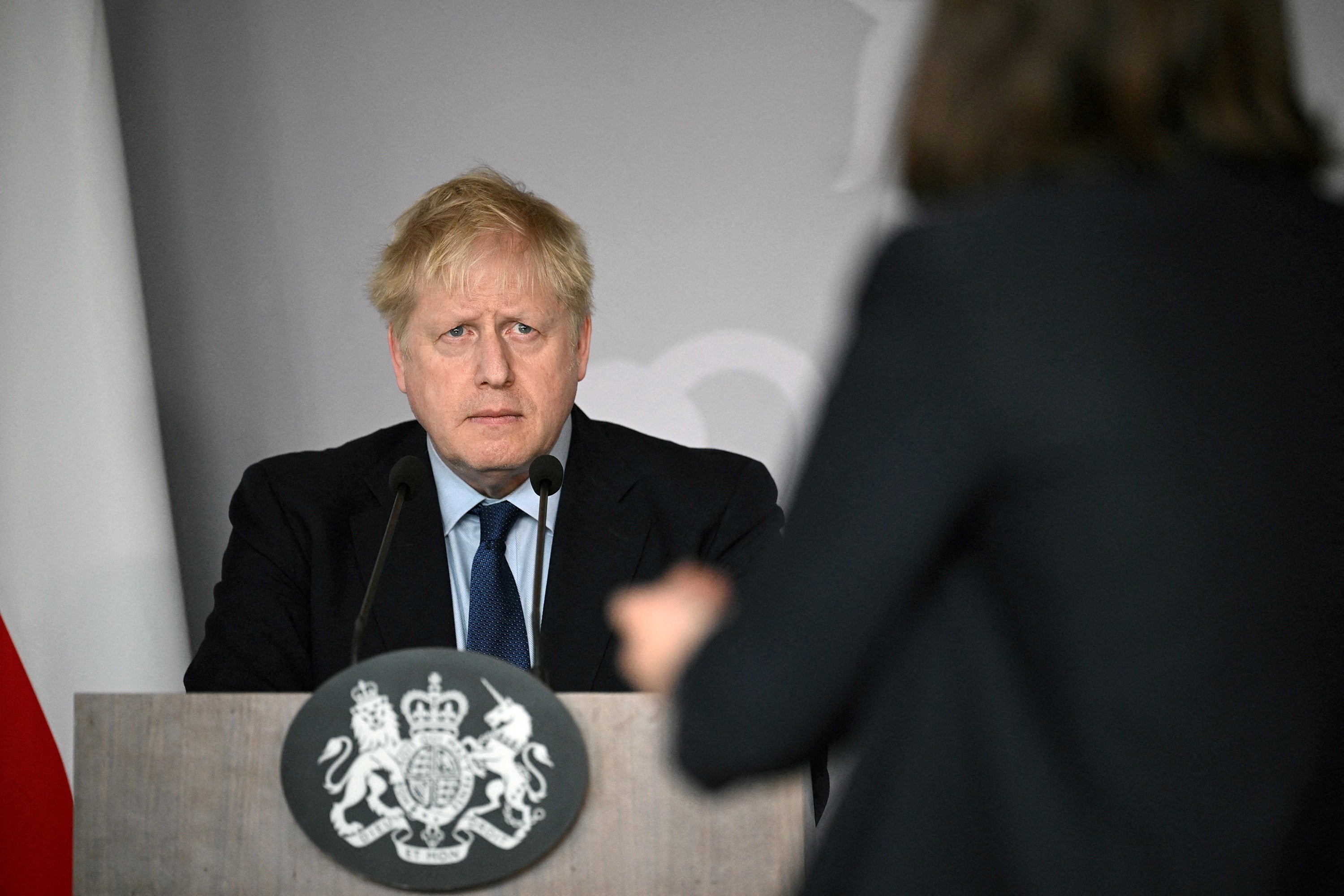 Boris Johnson fields a question from Ukrainian activist Daria Kaleniuk about the need for a no-fly zone during a news conference at the British embassy in Warsaw on Tuesday
