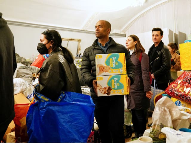 <p>People queue to make donations in support of Ukrainian refugees at The White Eagle Club in Balham, south London</p>