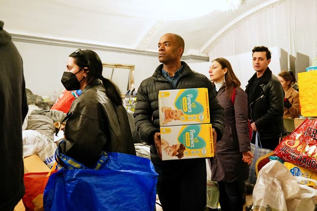 <p>People queue to make donations in support of Ukrainian refugees at The White Eagle Club in Balham, south London</p>
