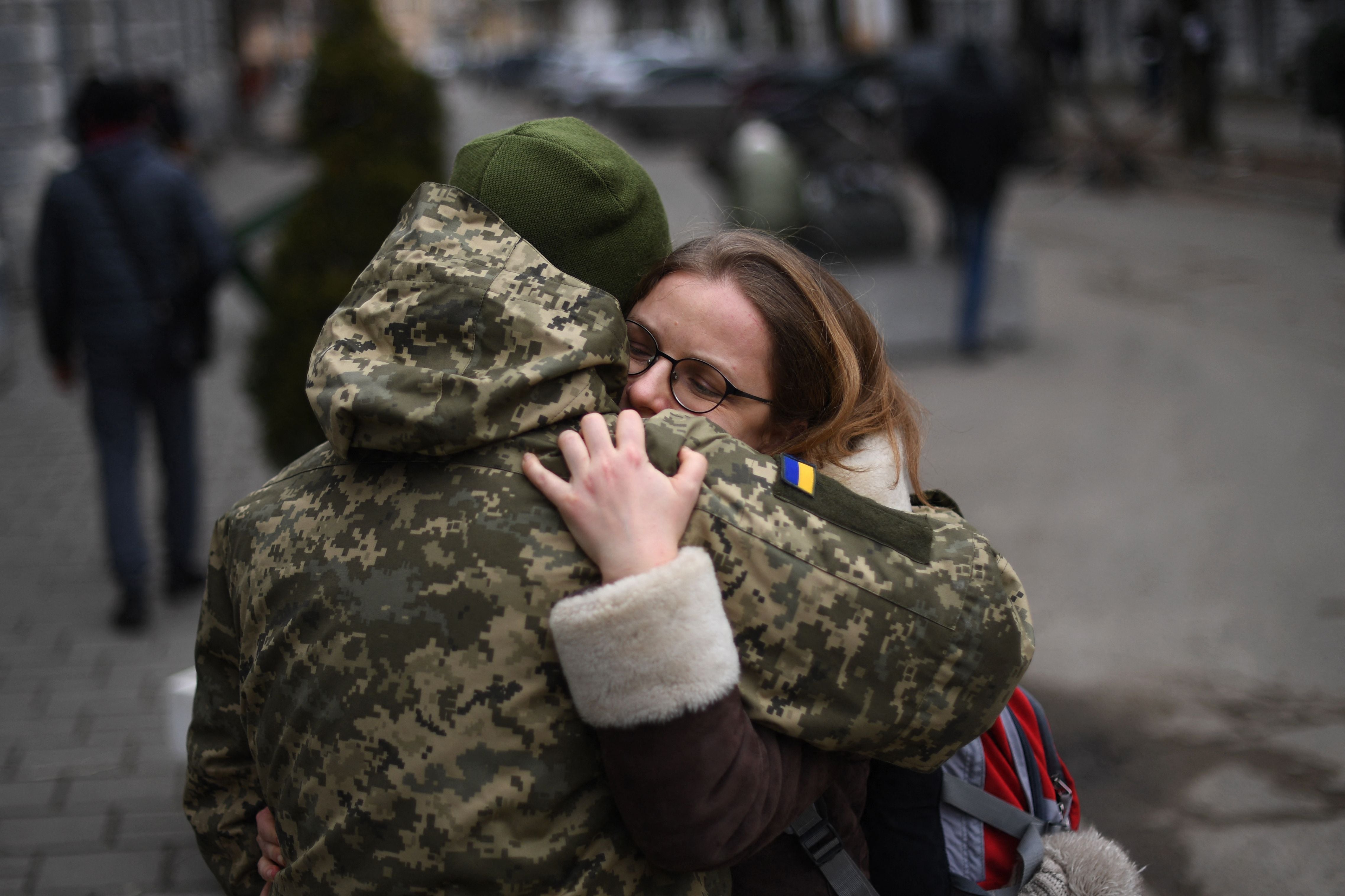 An Ukrainian soldier hugs his partner in Lviv