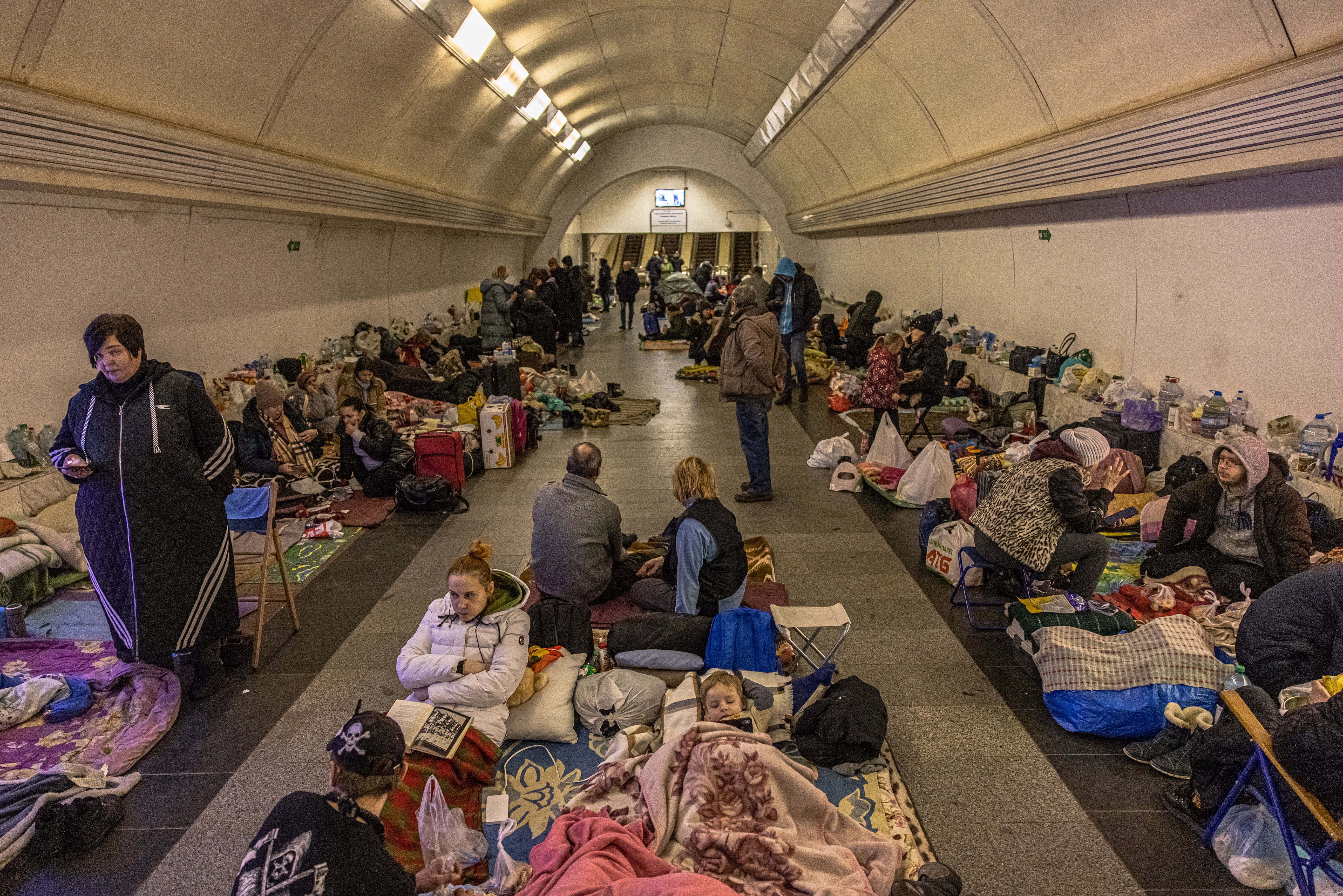 People inside Dorohozhychi subway station in the Ukrainian capital of Kyiv which has been turned into a bomb shelter