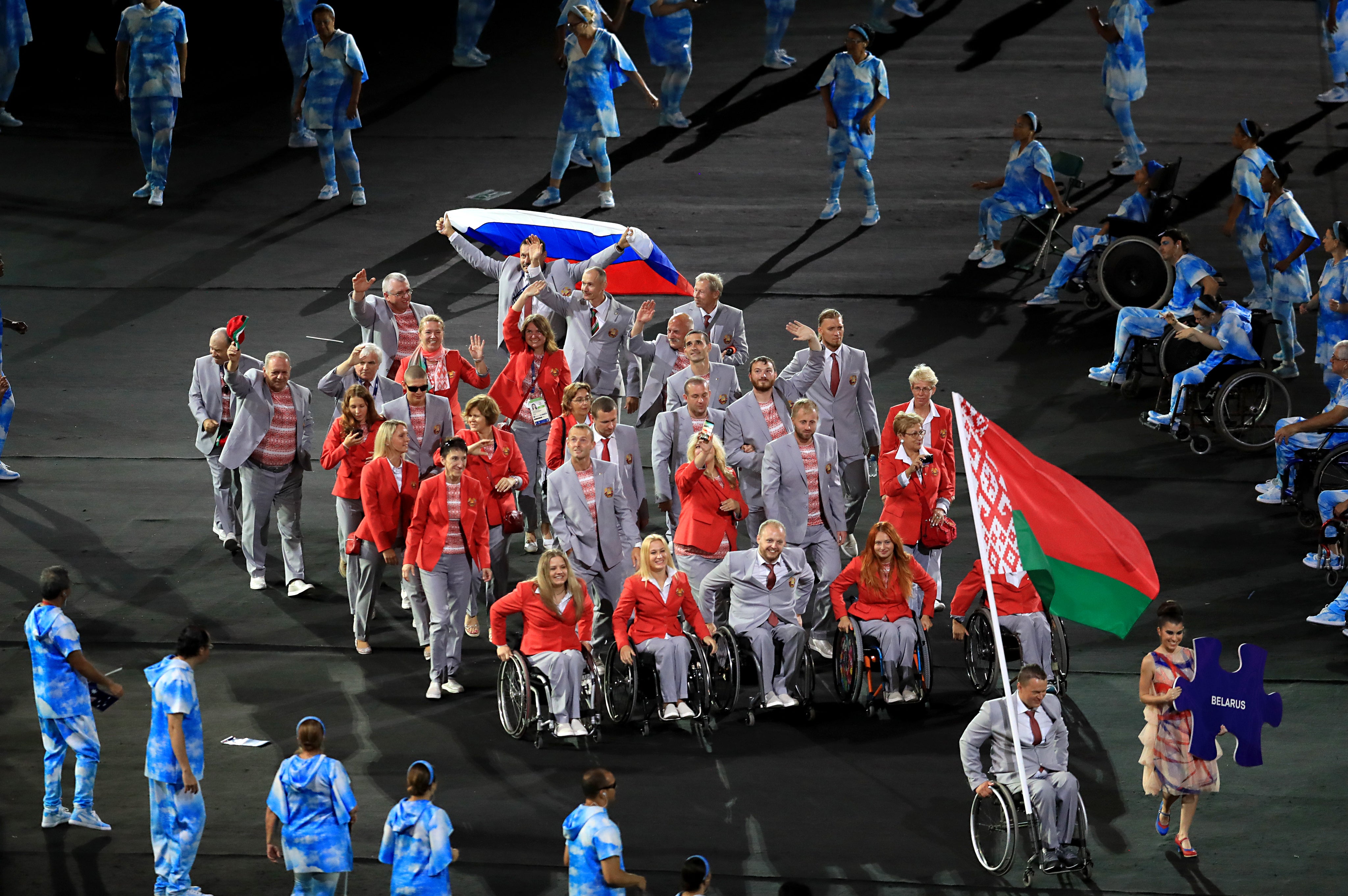 The Belarus team with a member waving a Russian flag during the opening ceremony of the 2016 Rio Paralympic Games