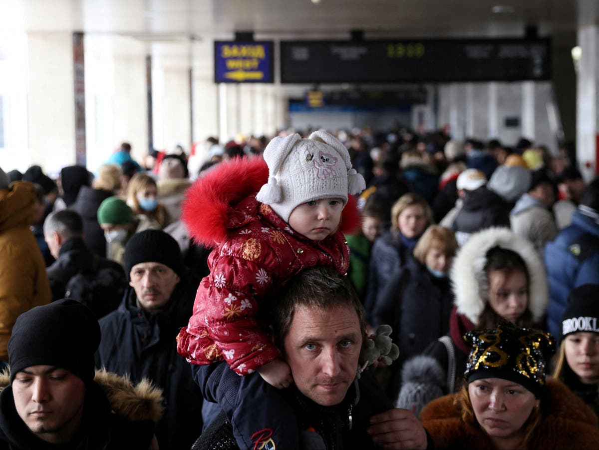 Thousands fight to get on trains out of Ukraine’s capital as 40-mile Russian convoy approaches