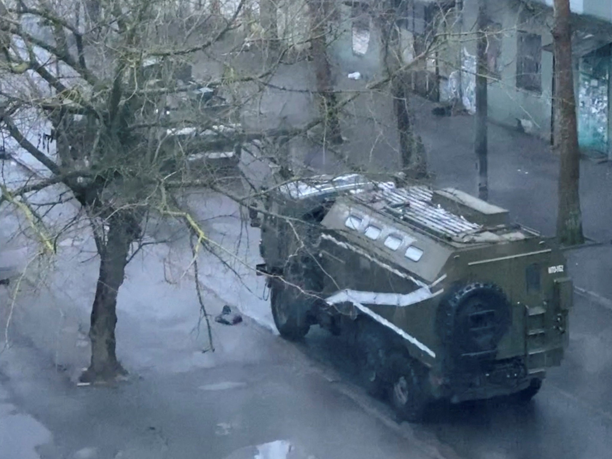 A military truck and tank on a Kherson street on Tuesday