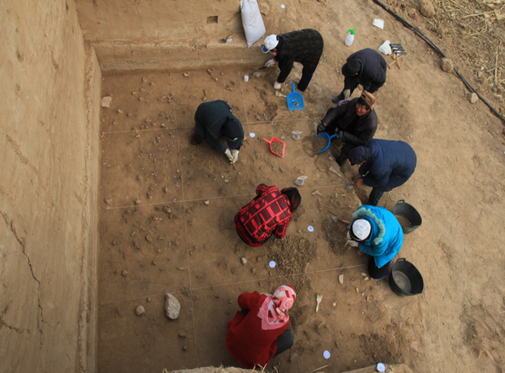 <p>Archaeologists excavating the well-preserved surface at the Xiamabei site in northern China, showing stone tools, fossils, ochre and red pigments</p>