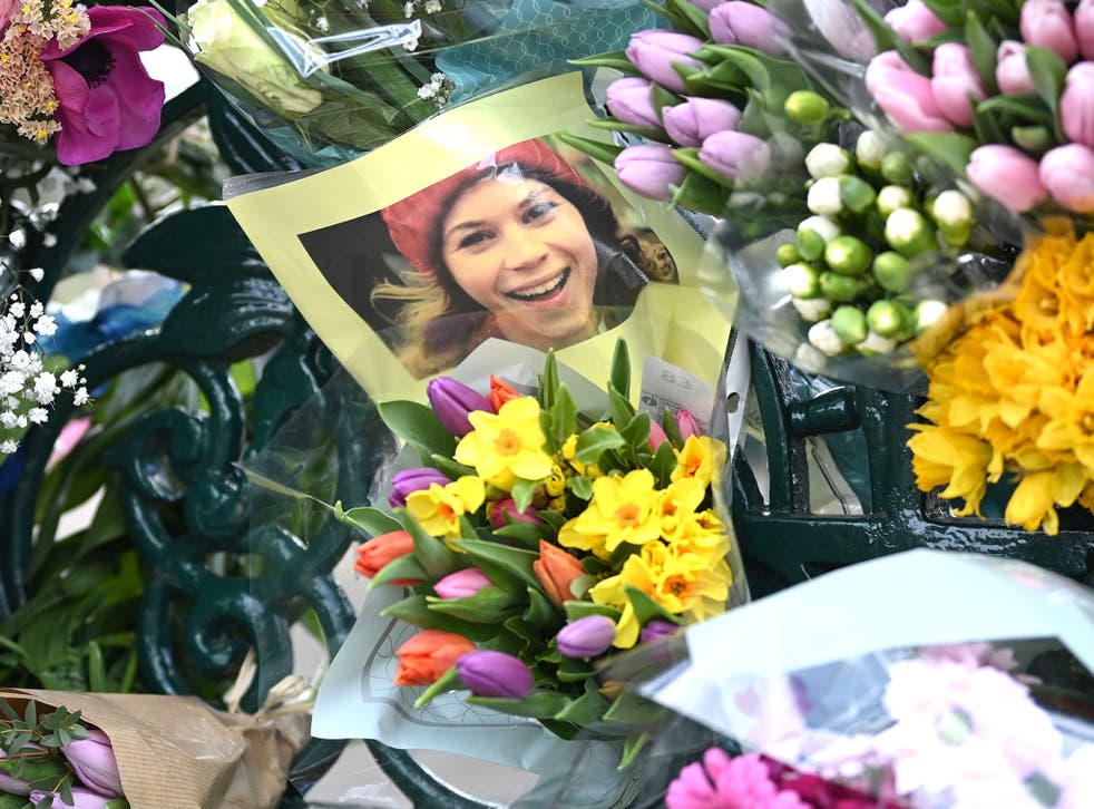 <p>A photograph of Sarah Everard is left with tributes to her at the bandstand on Clapham Common on 13 March 2021</p>