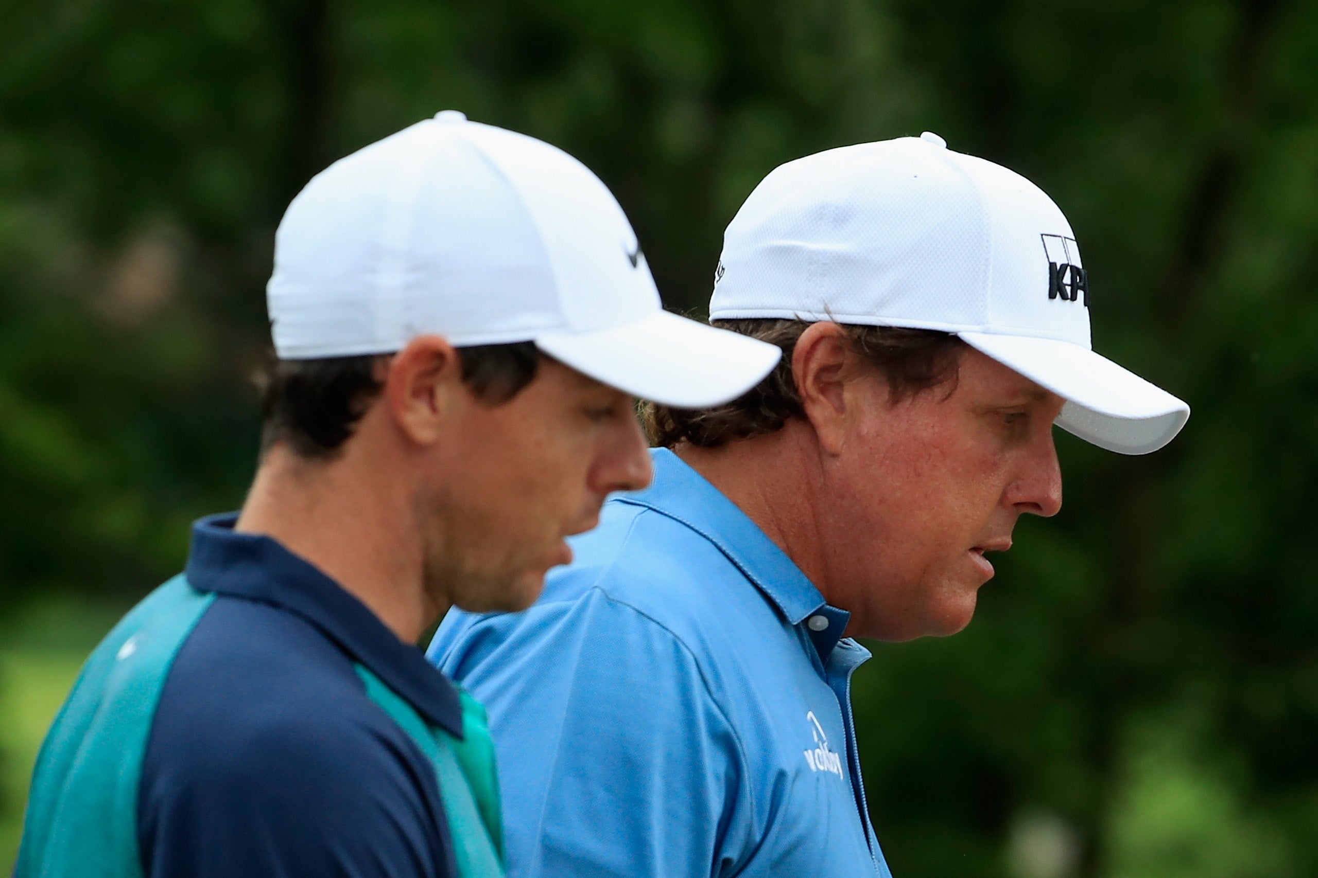 Rory McIlroy (left) hopes that Phil Mickelson is soon back playing on tour