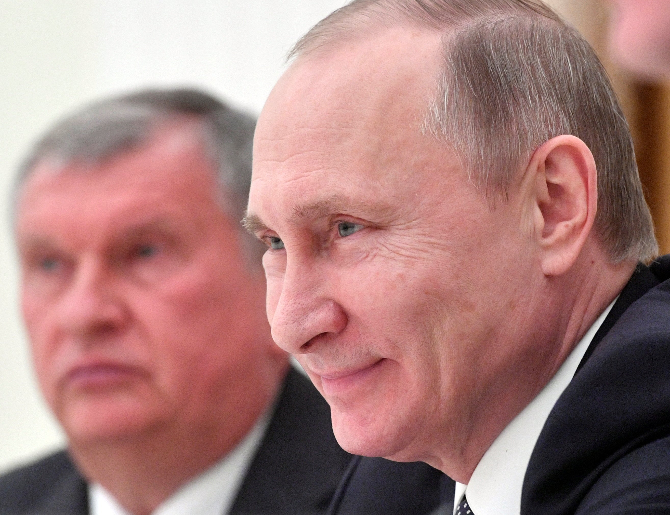 Sechin (left) is pictured alongside Putin in 2017