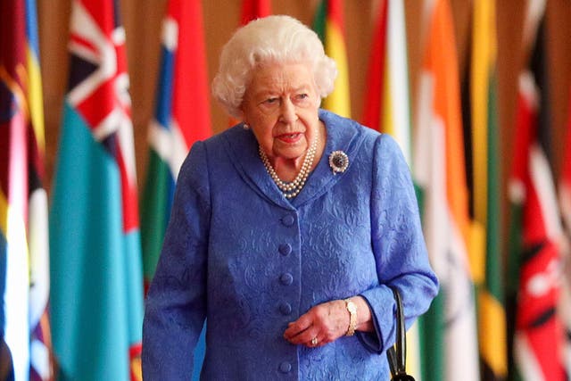 <p>Queen Elizabeth II walks past Commonwealth flags in St George’s Hall at Windsor Castle on 6 March, 2021</p>
