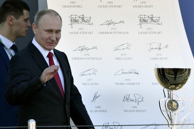 <p>Vladimir Putin presents the trophy at the Russian Grand Prix in 2017</p>