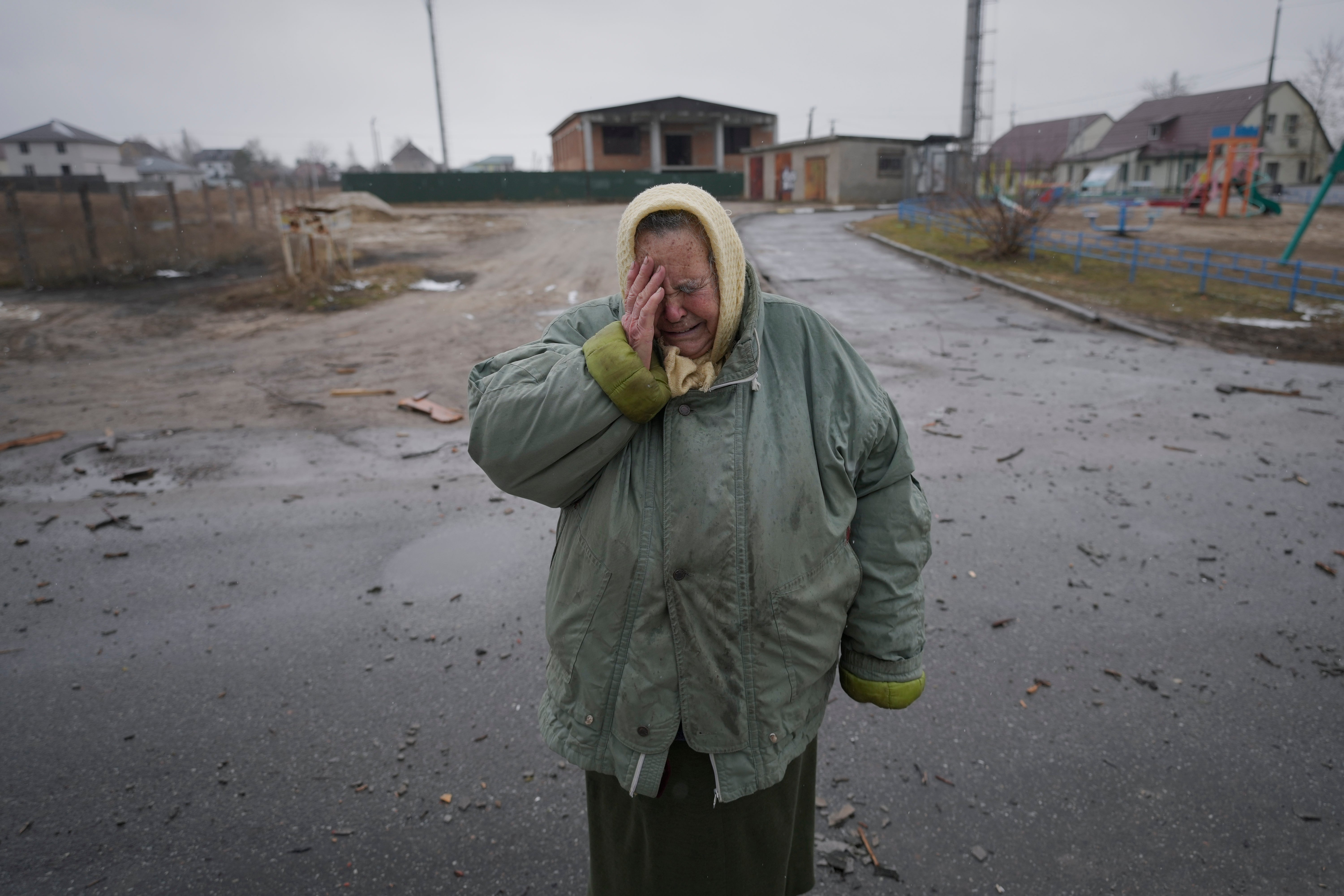 A woman cries outside houses damaged by a Russian airstrike, according to locals, in Gorenka (Vadim Ghirda/AP/PA)