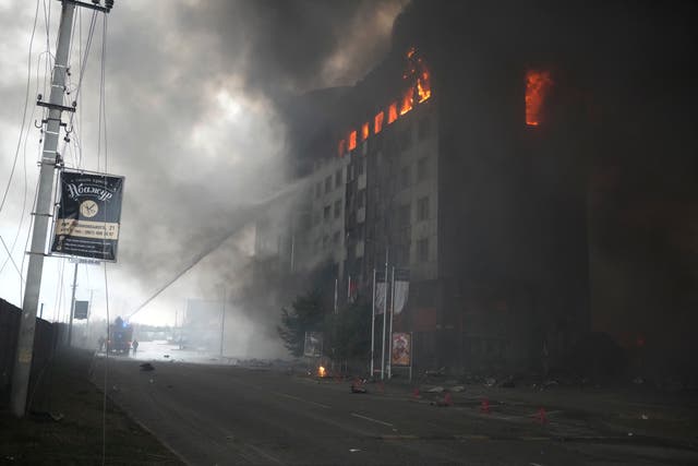 Firefighters hose down a burning building after bombing in Kyiv, Ukraine (Efrem Lukatsky/AP)