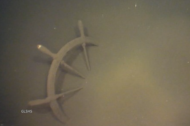 <p>The partially buried ship wheel of the Atlanta, a ship that wrecked in Lake Superior in 1891 that was recently discovered by the Great Lakes Shipwreck Historical Society</p>