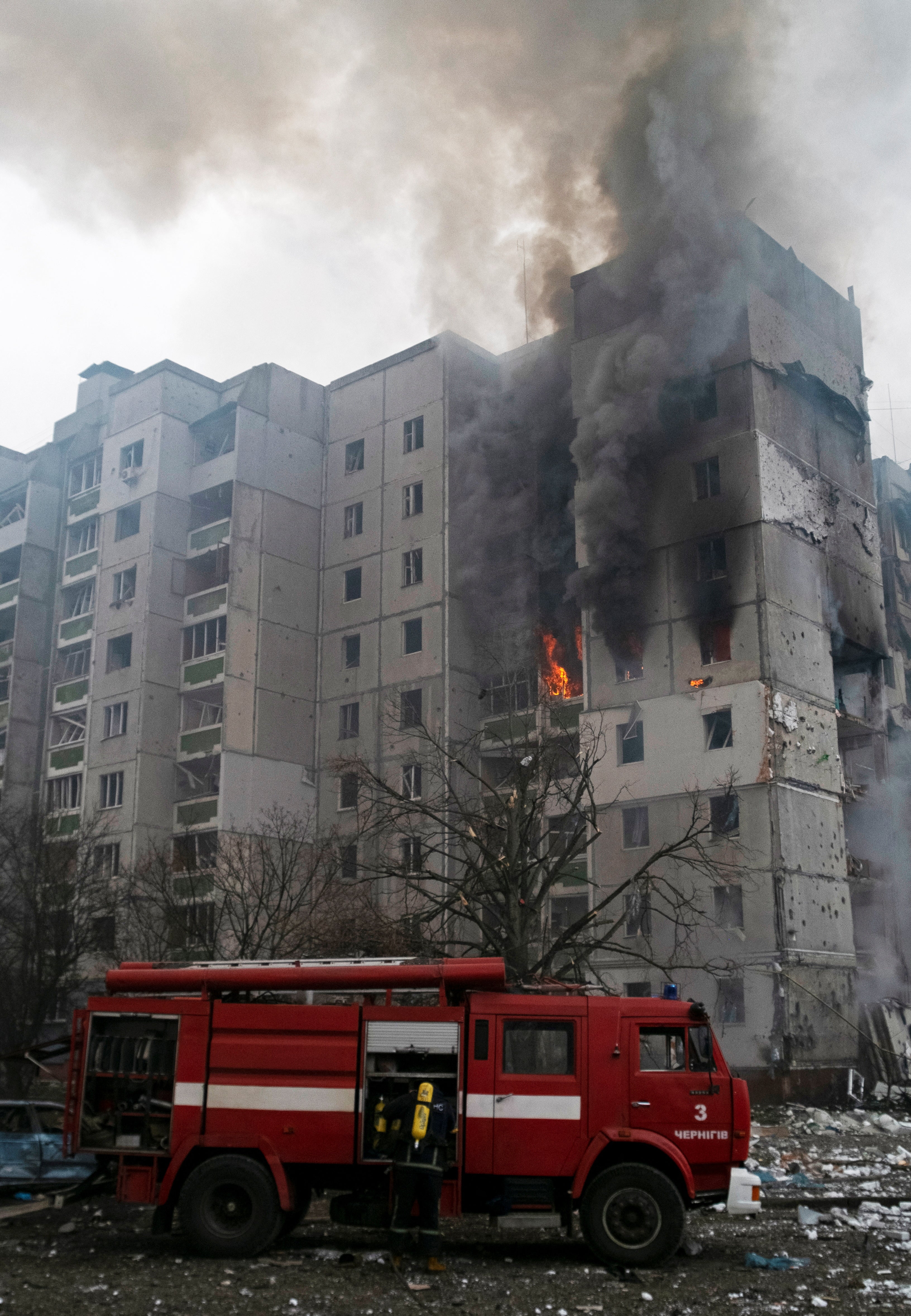 Flames and smoke in a residential building damaged by shelling