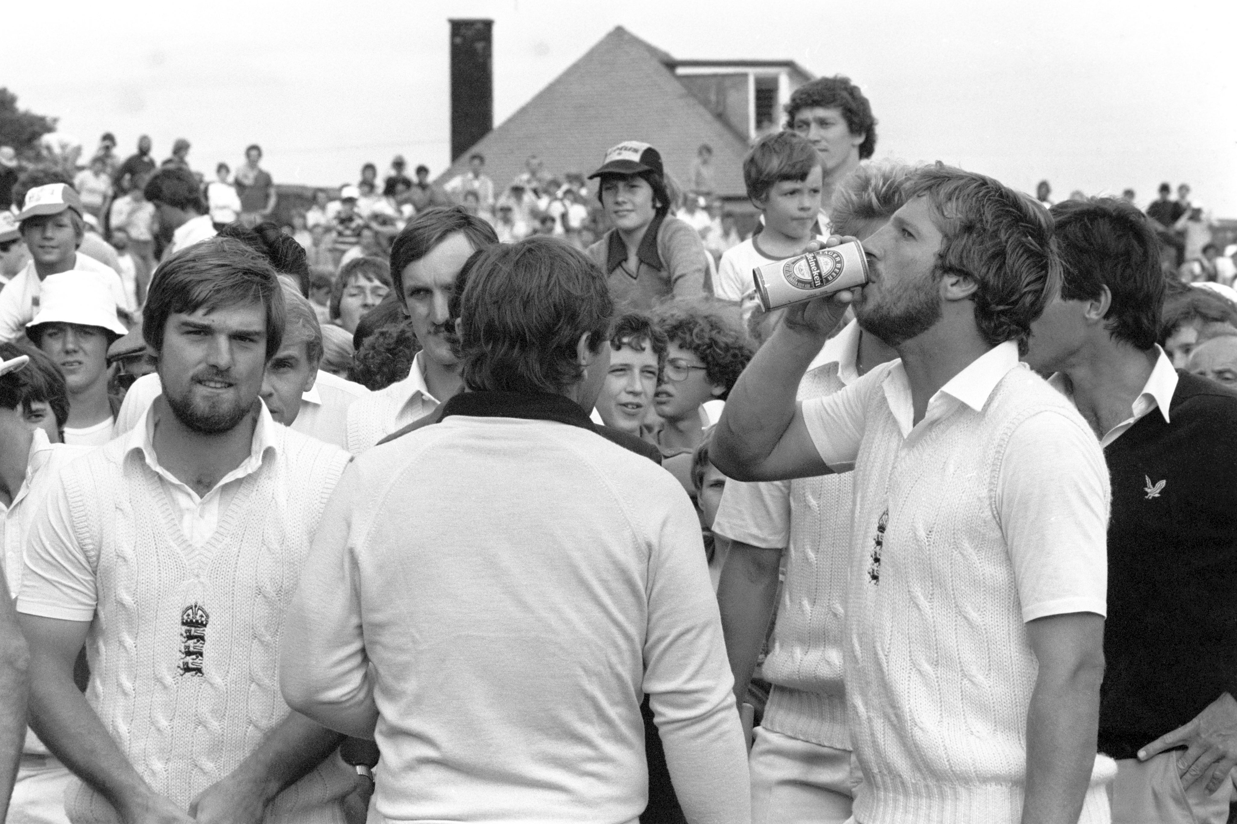 England hero Ian Botham downs a beer given to him by Marsh after the fifth Test (PA)