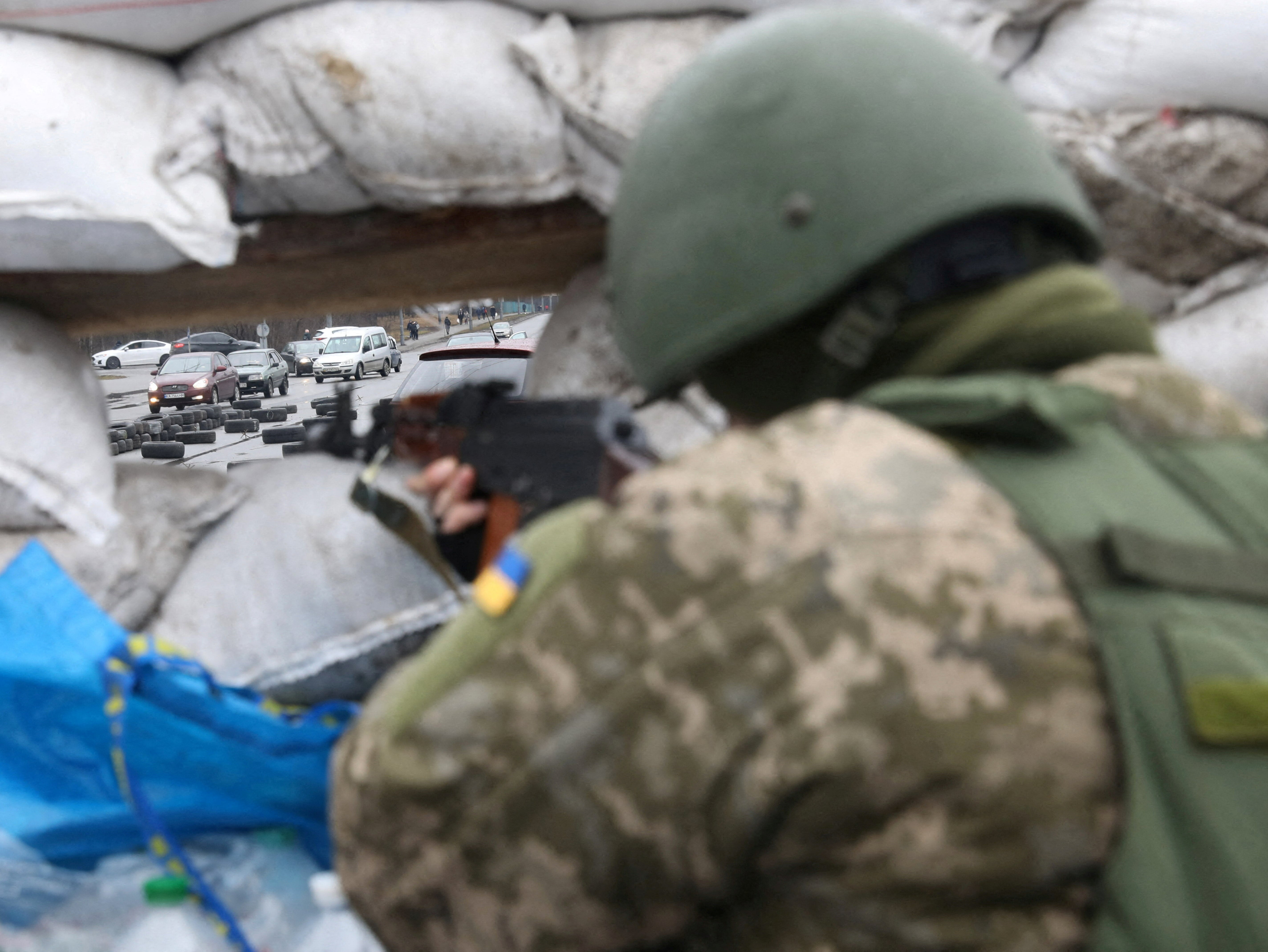 A member of the Territorial Defence Forces stands guard at a checkpoint, as Russia's invasion of Ukraine continues, in Kyiv, Ukraine