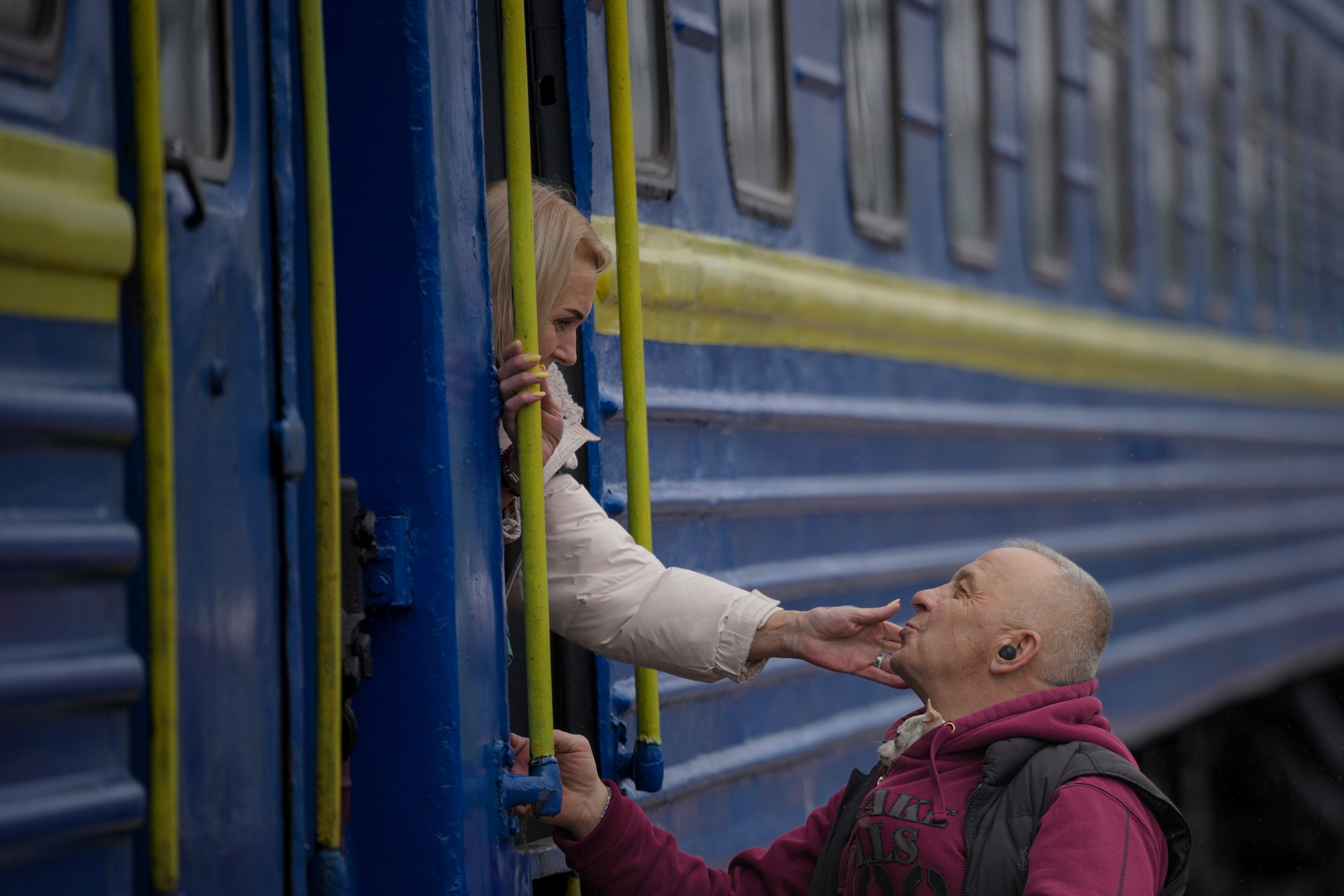 A woman bids a man goodbye after boarding a train bound for Lviv