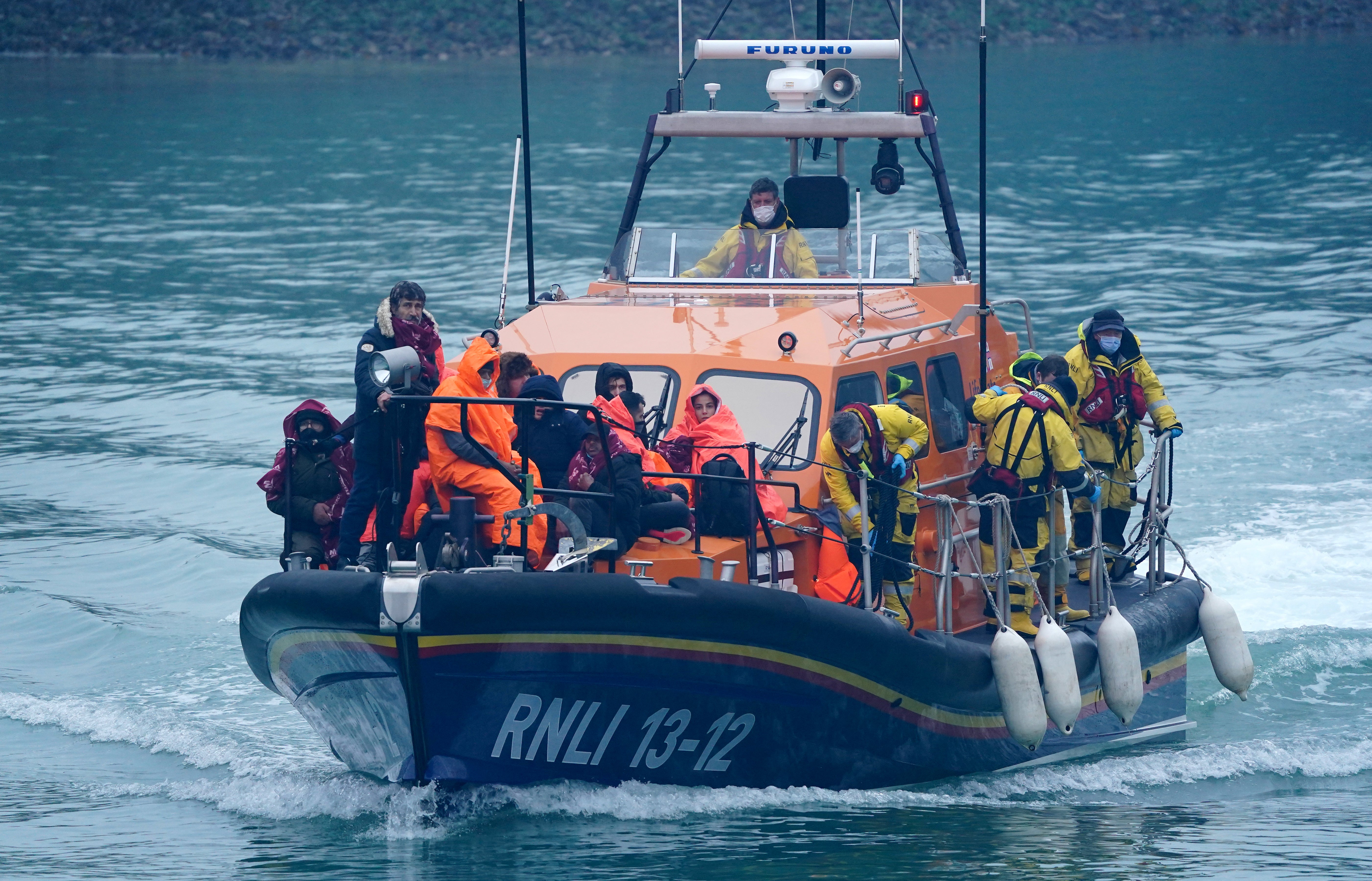 A group of people thought to be migrants are brought in to Dover, Kent, onboard an RNLI vessel following a small boat incident in the Channel (Gareth Fuller/PA)