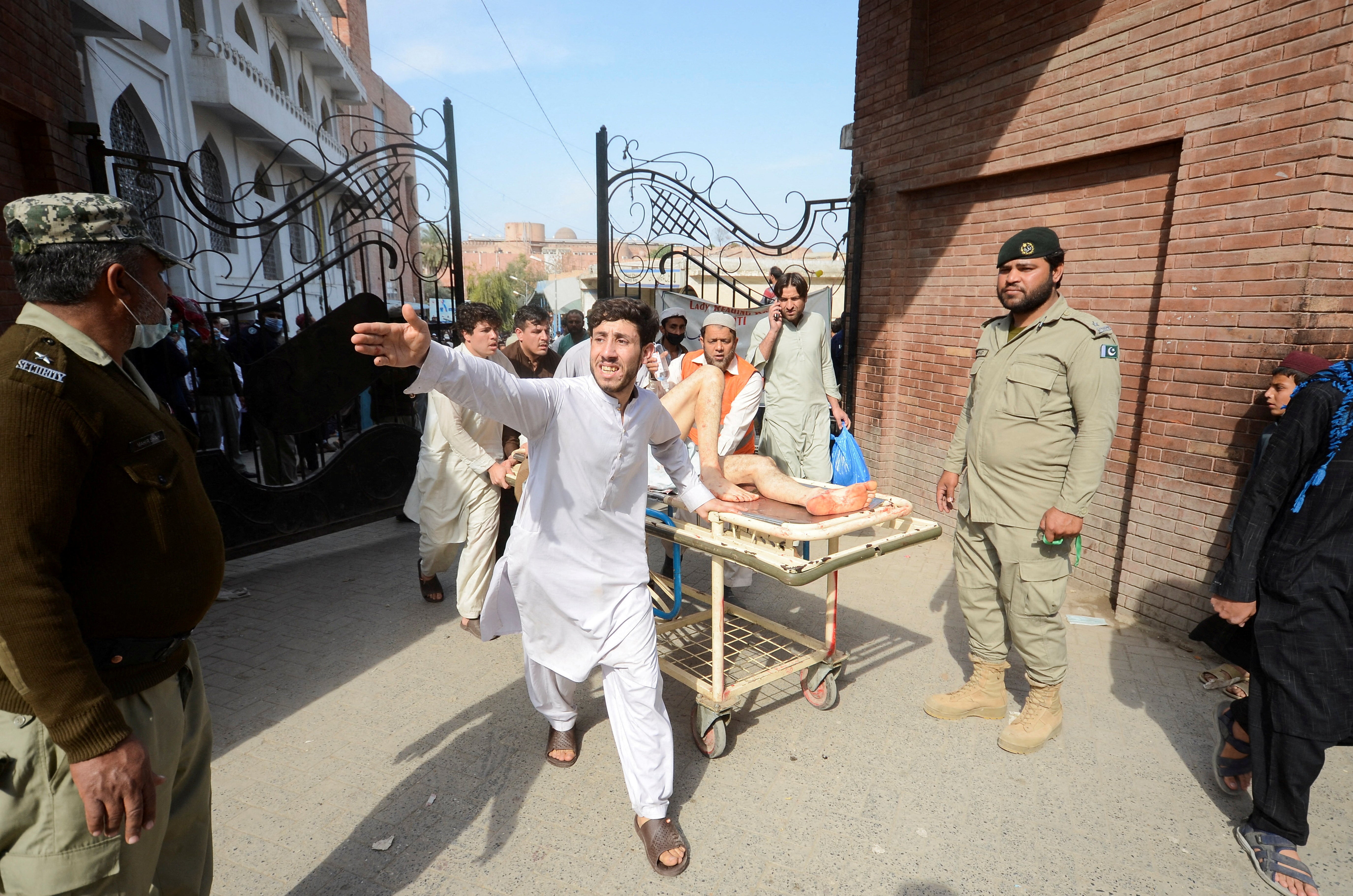 People move one of the wounded on a stretcher