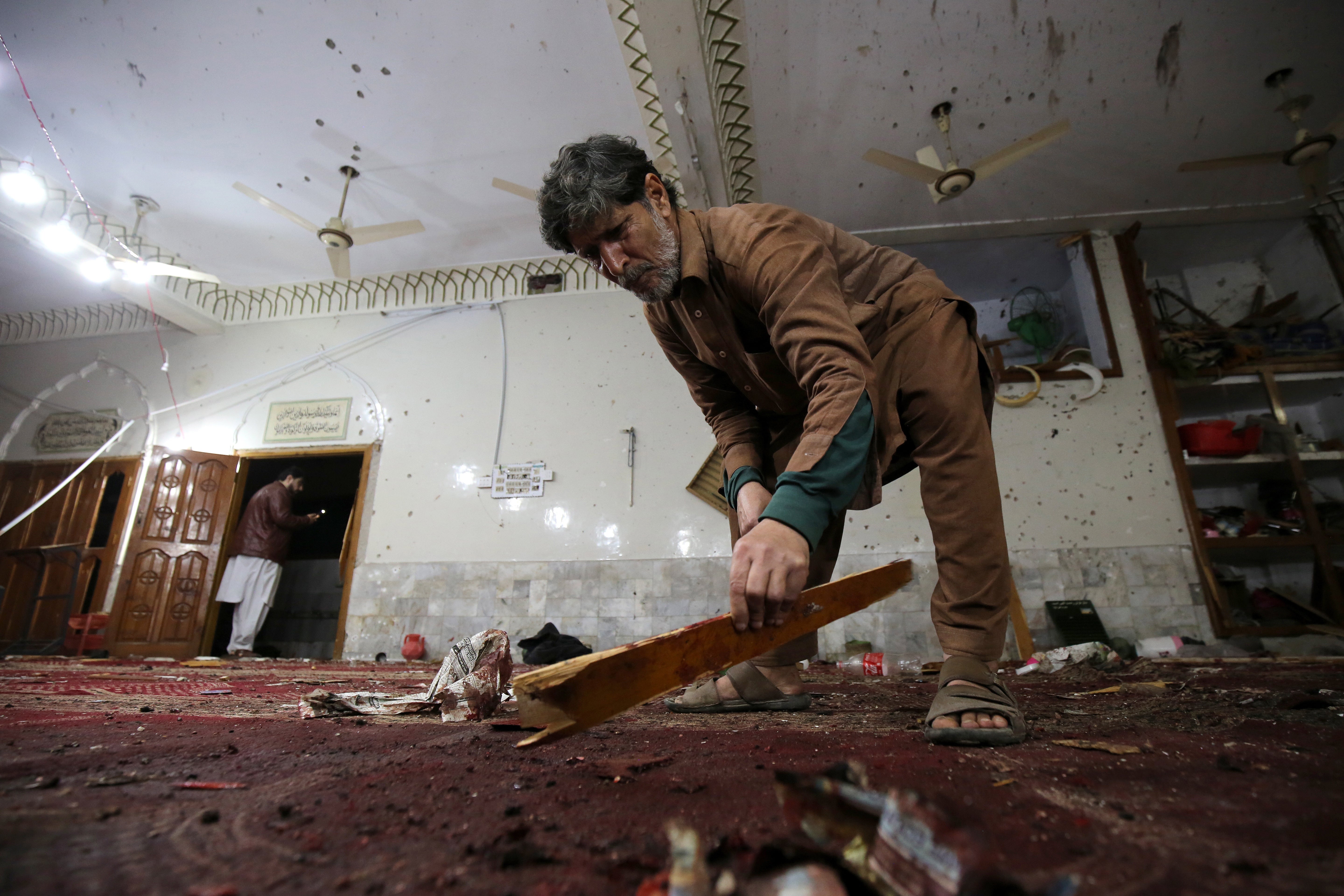 A man inspects the aftermath of the blast