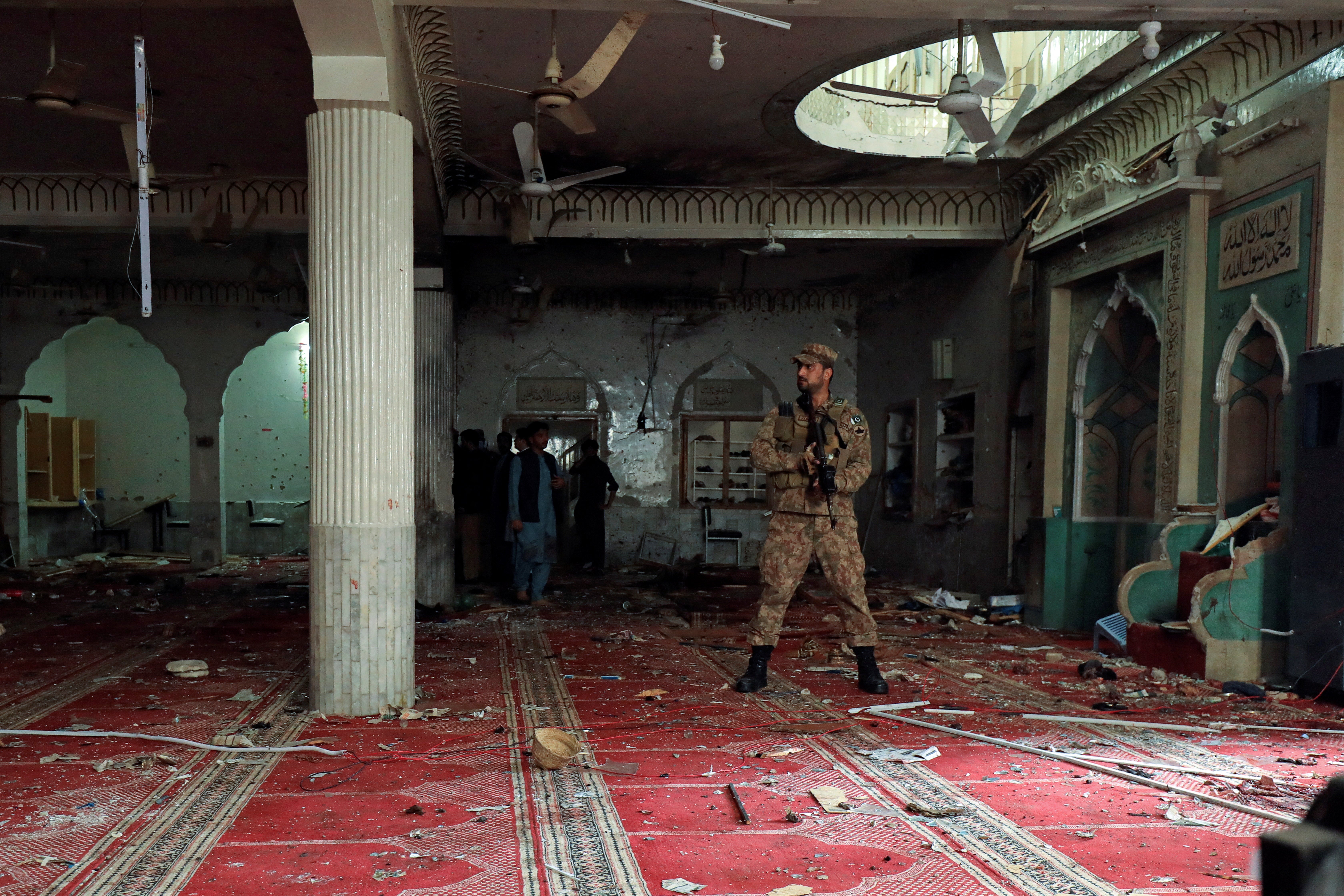 A soldier stands in the prayer hall following the explosion