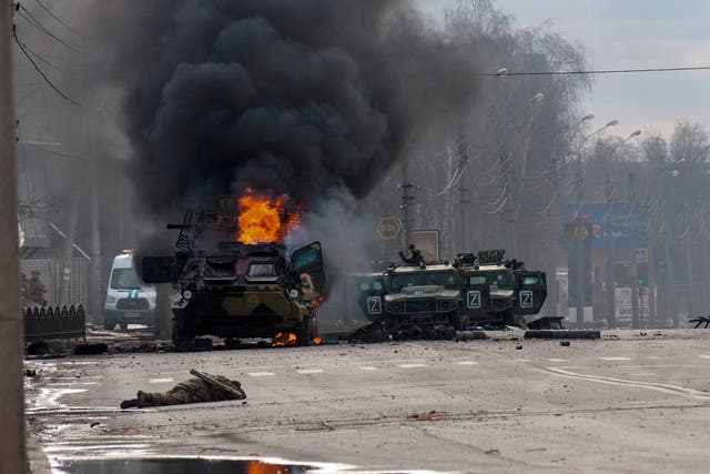 <p>File: A Russian armored personnel carrier burns amid damaged and abandoned light utility vehicles after fighting in Kharkiv, Ukraine on 27 February</p>
