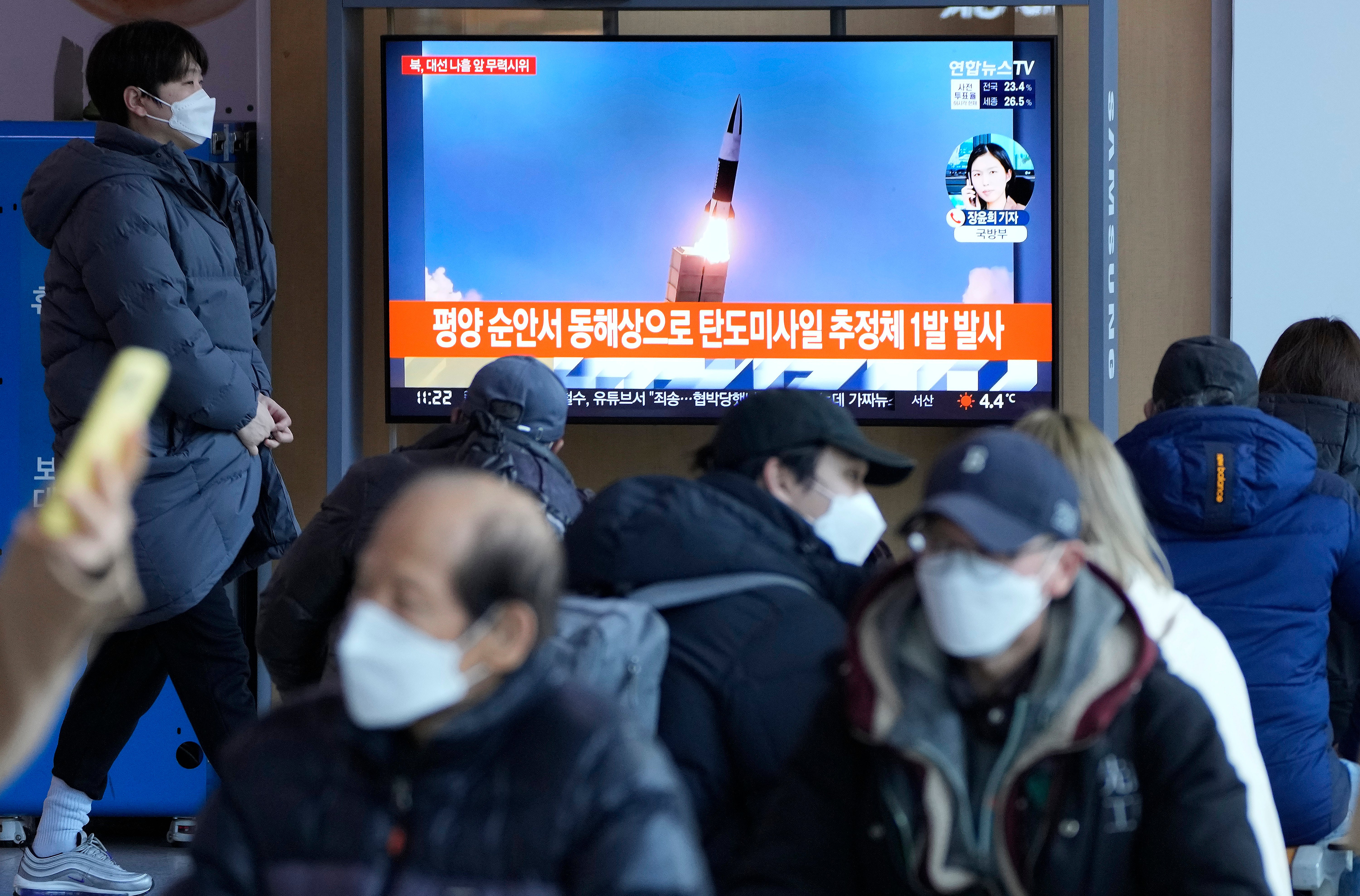 File: People watch a TV showing a file image of North Korea’s missile launch during a news programme at the Seoul Railway Station in South Korea