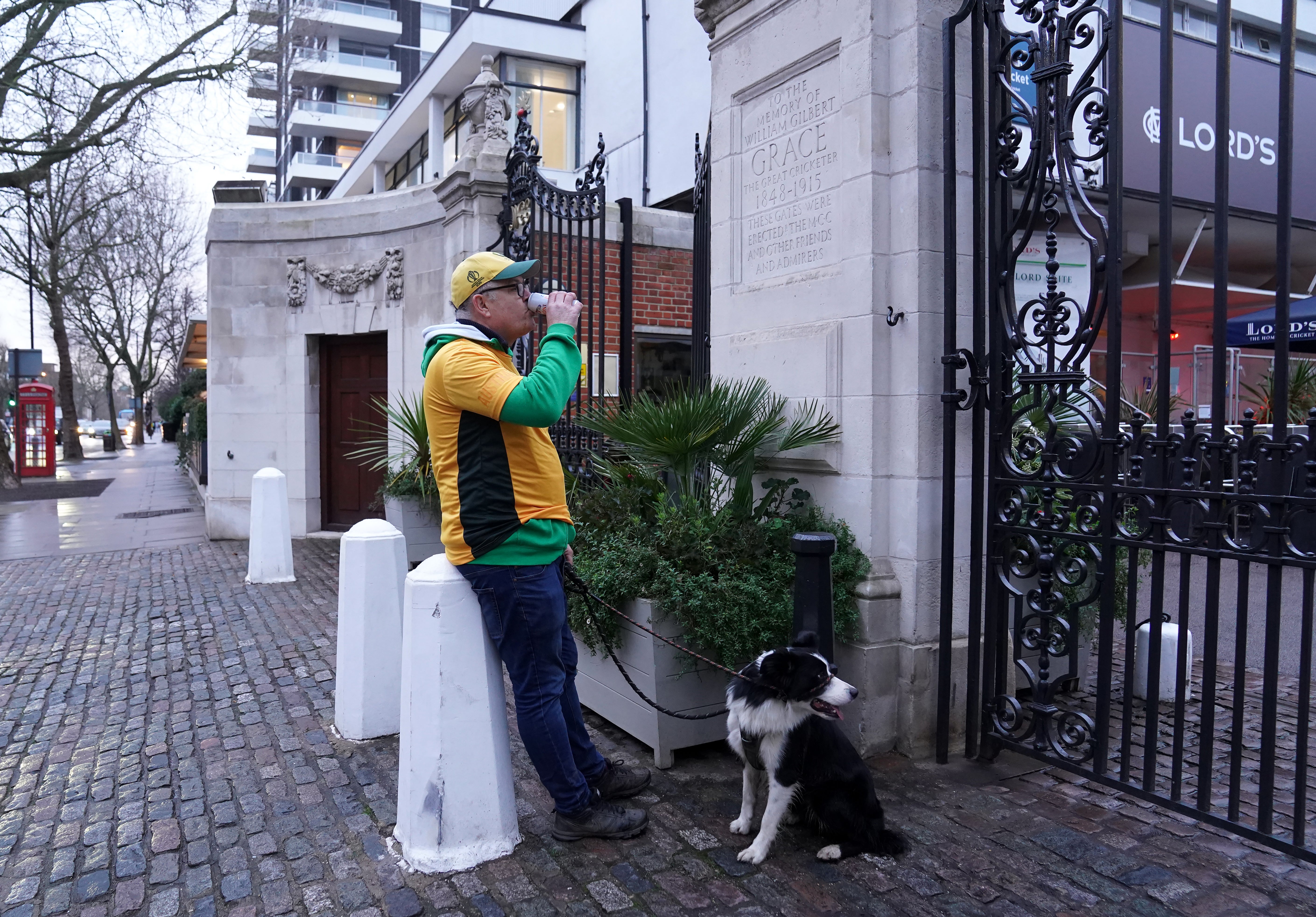 Derek Ford from Sydney, and his dog Rex, pay their respects at the gates of Lord’s Cricket Ground (Stefan Rousseau/PA)