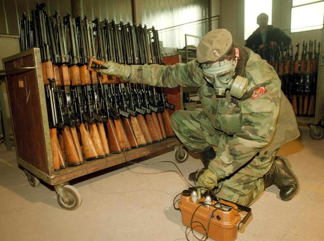 <p>A Bosnian Serb soldier measures radiation levels at a factory in the town of Bratunac</p>
