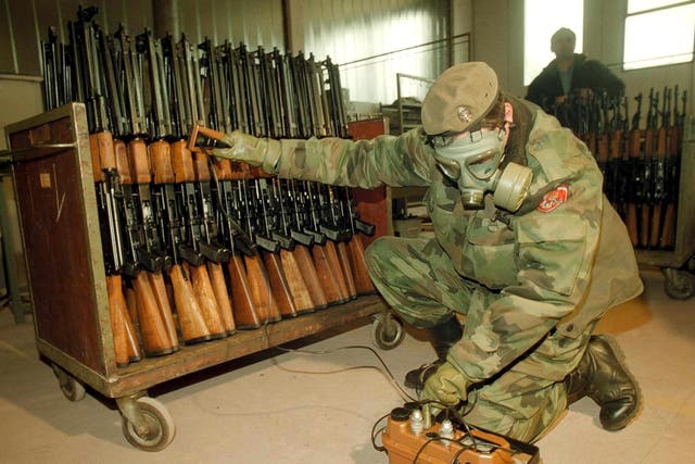 <p>A Bosnian Serb soldier measures radiation levels at a factory in the town of Bratunac</p>