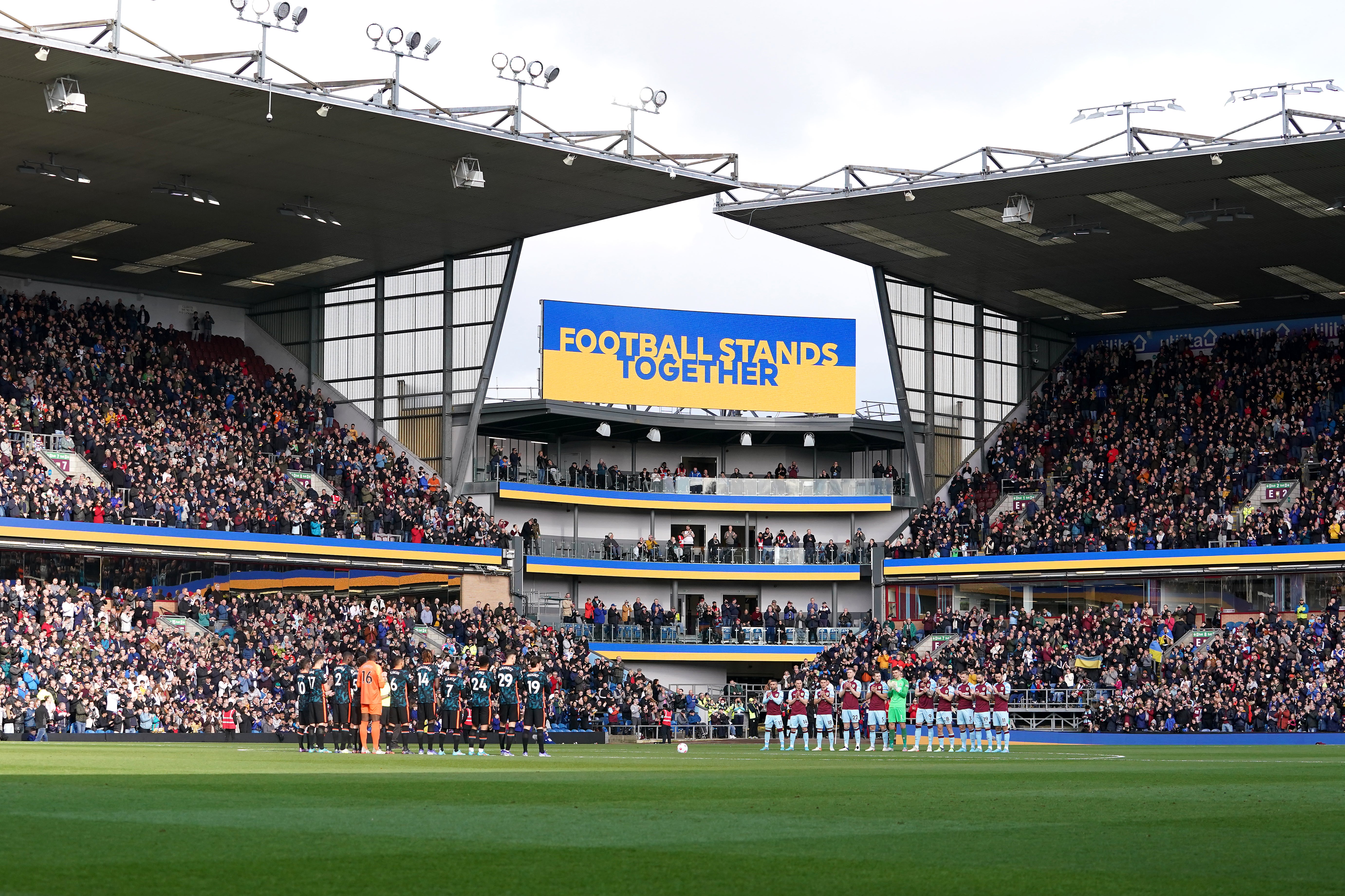 Players from Burnley and Chelsea stand for a moment of reflection and solidarity with Ukraine before kick-off (Martin Rickett/PA)