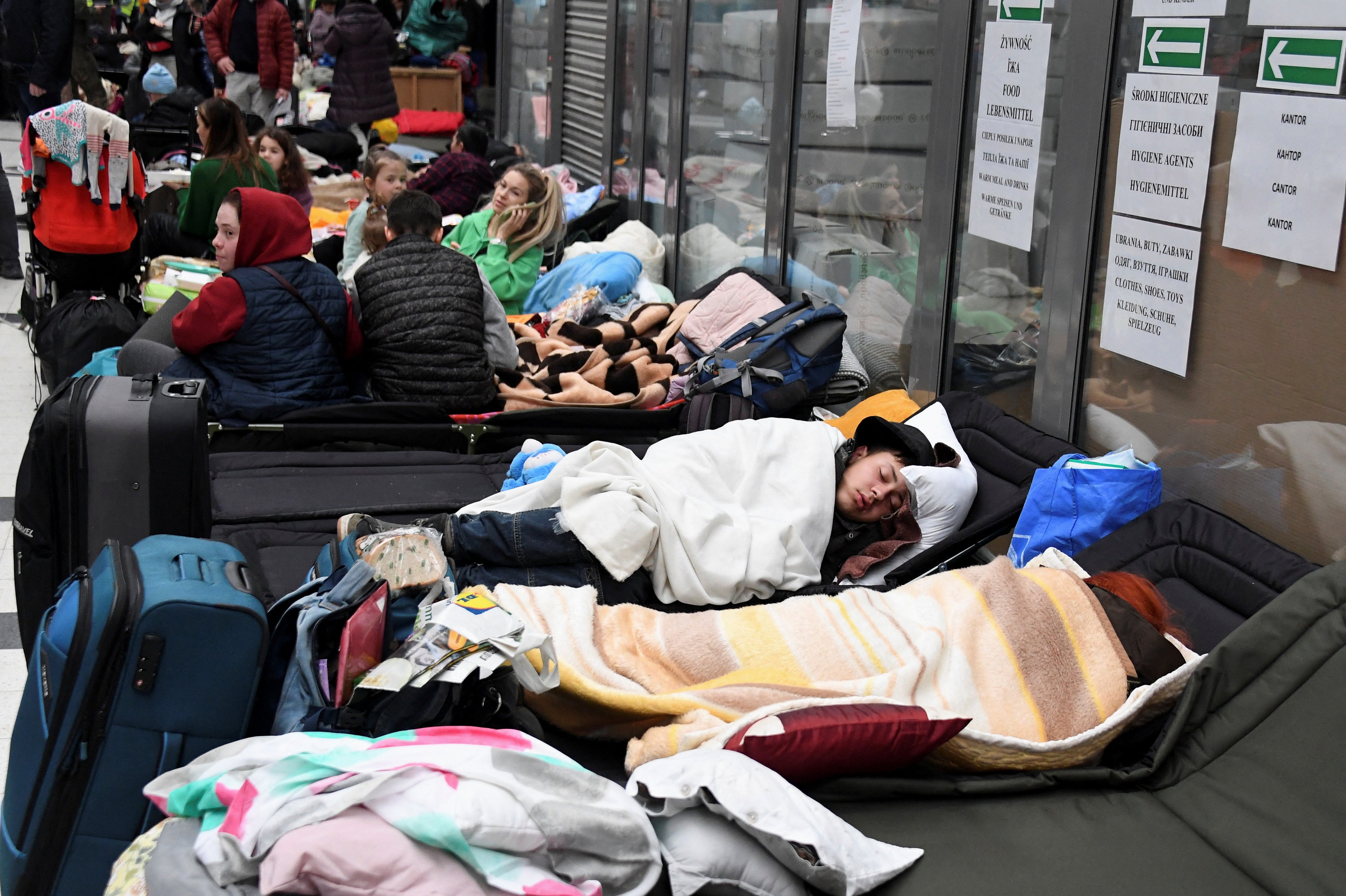 People rest at a refugee reception center at the Ukrainian-Polish border crossing in Korczowa
