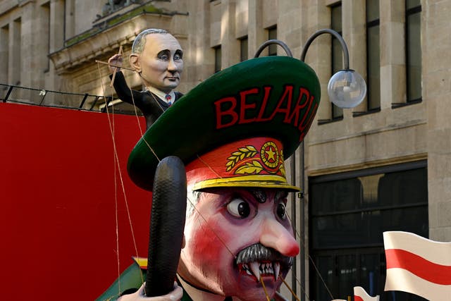 <p>A carnival float featuring Russian President Putin (top) handling Belarus’s President Lukashenko like a puppet at a peace march, ‘Freedom for Ukraine’, in Cologne, Germany in February </p>