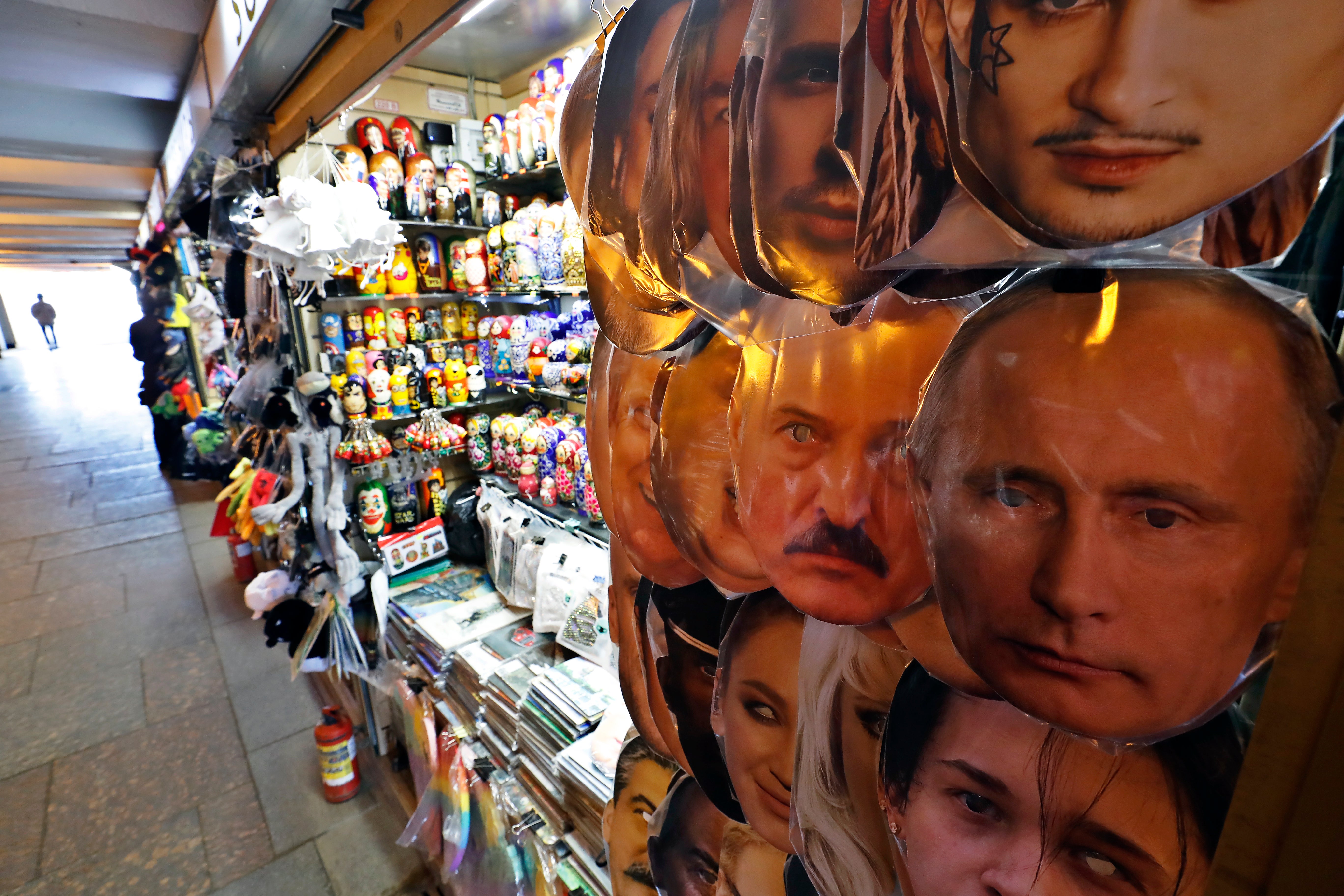 Masks with portraits of Vladimir Putin and Alexander Lukashenko on display in a street market in St Petersburg in February