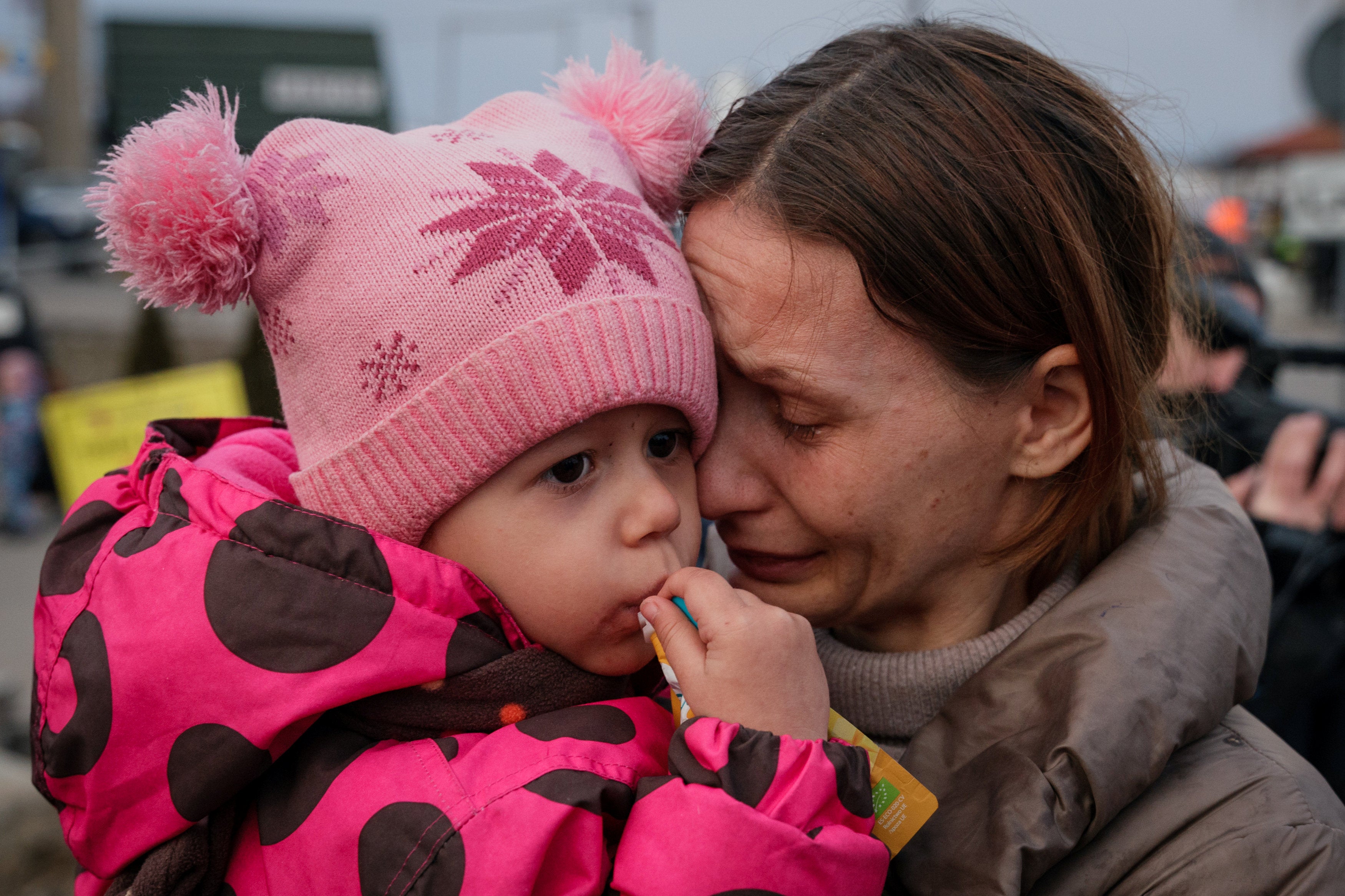 A Ukrainian family is reunited after crossing the border to Medyka, Poland